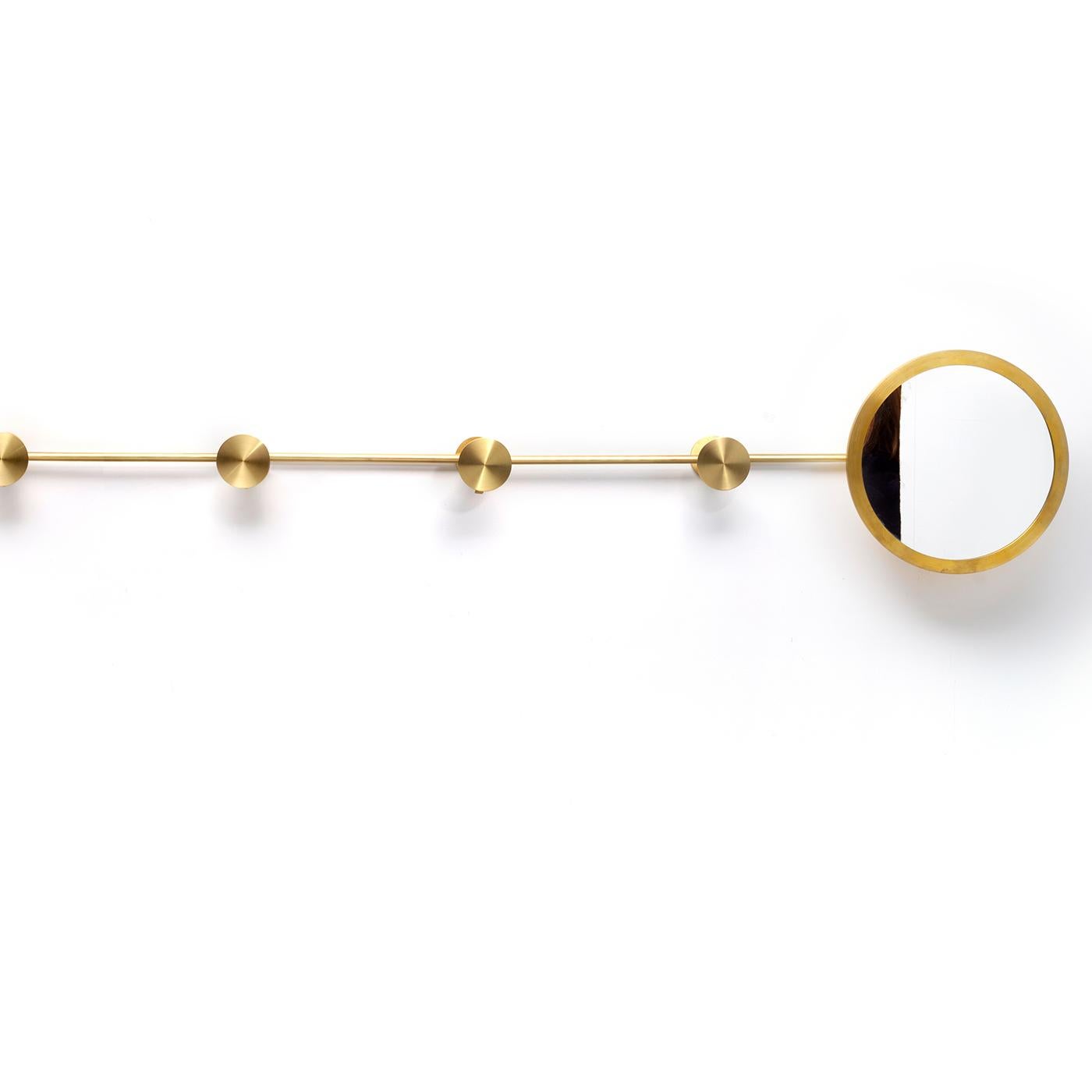 This unique coat rack with mirror features a satin brass structure with six knobs made of flat disks (6 cm) each concealing a hook and a round mirror, 25 cm in diameter, on one side. The linear structure is flexible and can be displayed in a