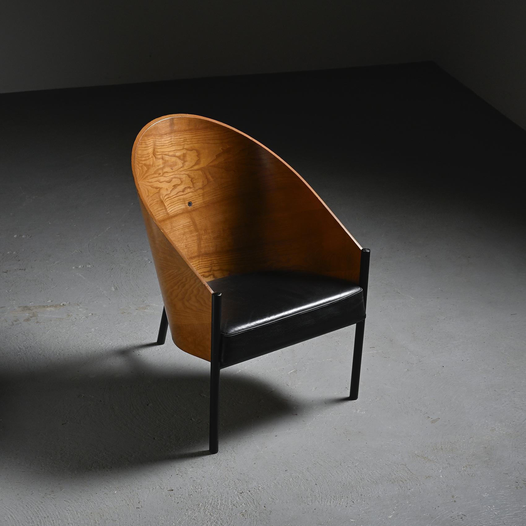 
 Costes armchair with tubular structure in black lacquered steel, shell in bent plywood with mahogany finish, fixed cushion padded with foam and covered in black leather. An icon of 1980s design, it remains one of Philippe Starck's most emblematic