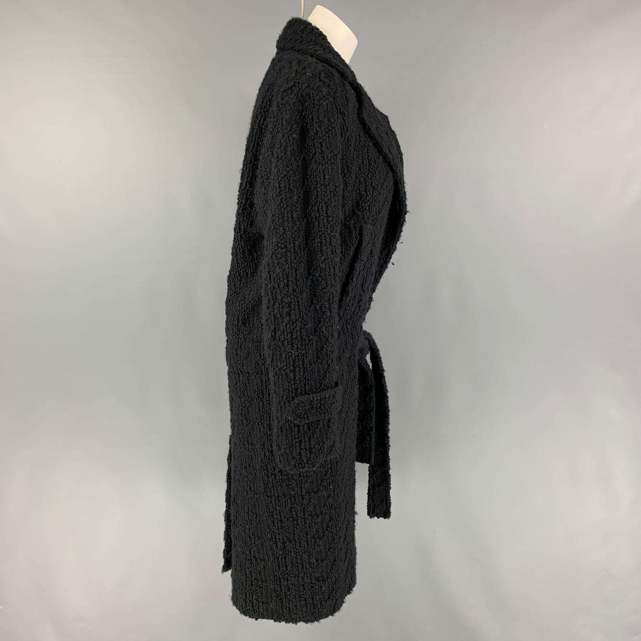 CoSTUME NATIONAL coat comes in a black wool / polyamide with a full liner featuring a notch lapel, belted detail, slit pockets, and a buttoned closure. Made in Italy.
Very Good
Pre-Owned Condition. 

Marked:   38 

Measurements: 
 
Shoulder:
16