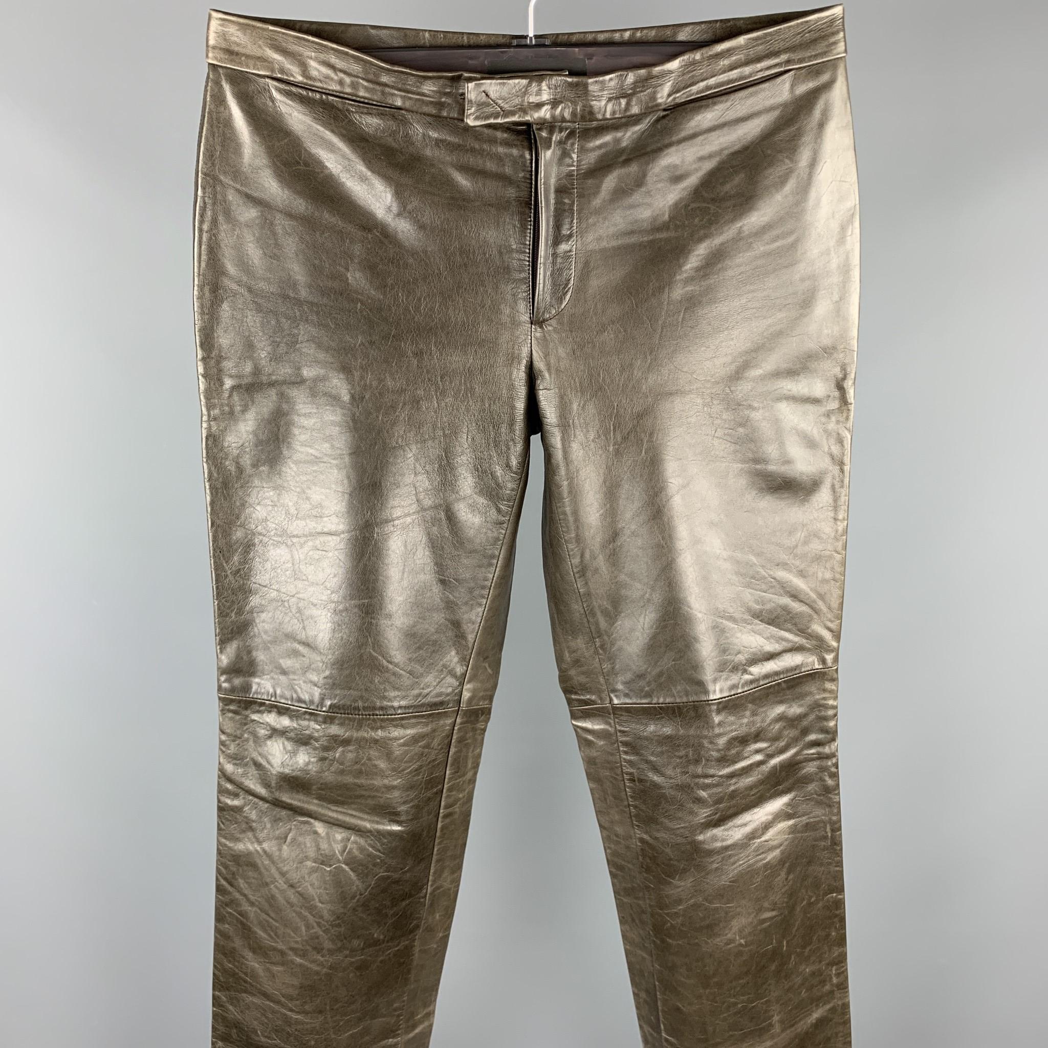 CoSTUME NATIONAL flat front pants come in distressed taupe leather with a tab waistband. Made in Italy.

Good Pre-Owned Condition.
Marked: IT 52

Measurements:

Waist: 36 in.
Rise: 9.5 in.
Inseam: 35 in.