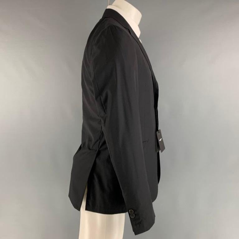 CoSTUME NATIONAL sport coat comes in black wool and silk woven material featuring a notch lapel, single breasted, two button front, and double vented back. Made in Italy.New With Tags. 

Marked:   50 

Measurements: 
 
Shoulder: 17 inches Chest: 42