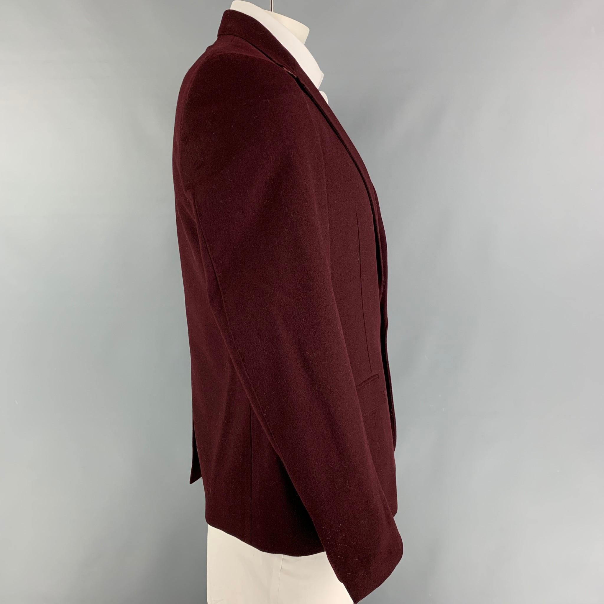 CoSTUME NATIONAL sport coat comes in a burgundy wool with a full liner featuring a notch lapel, flap pockets, single back vent, and  single button closure. Made in Italy. 

Very Good Pre-Owned Condition.
Marked: 52

Measurements:

Shoulder: 18.5