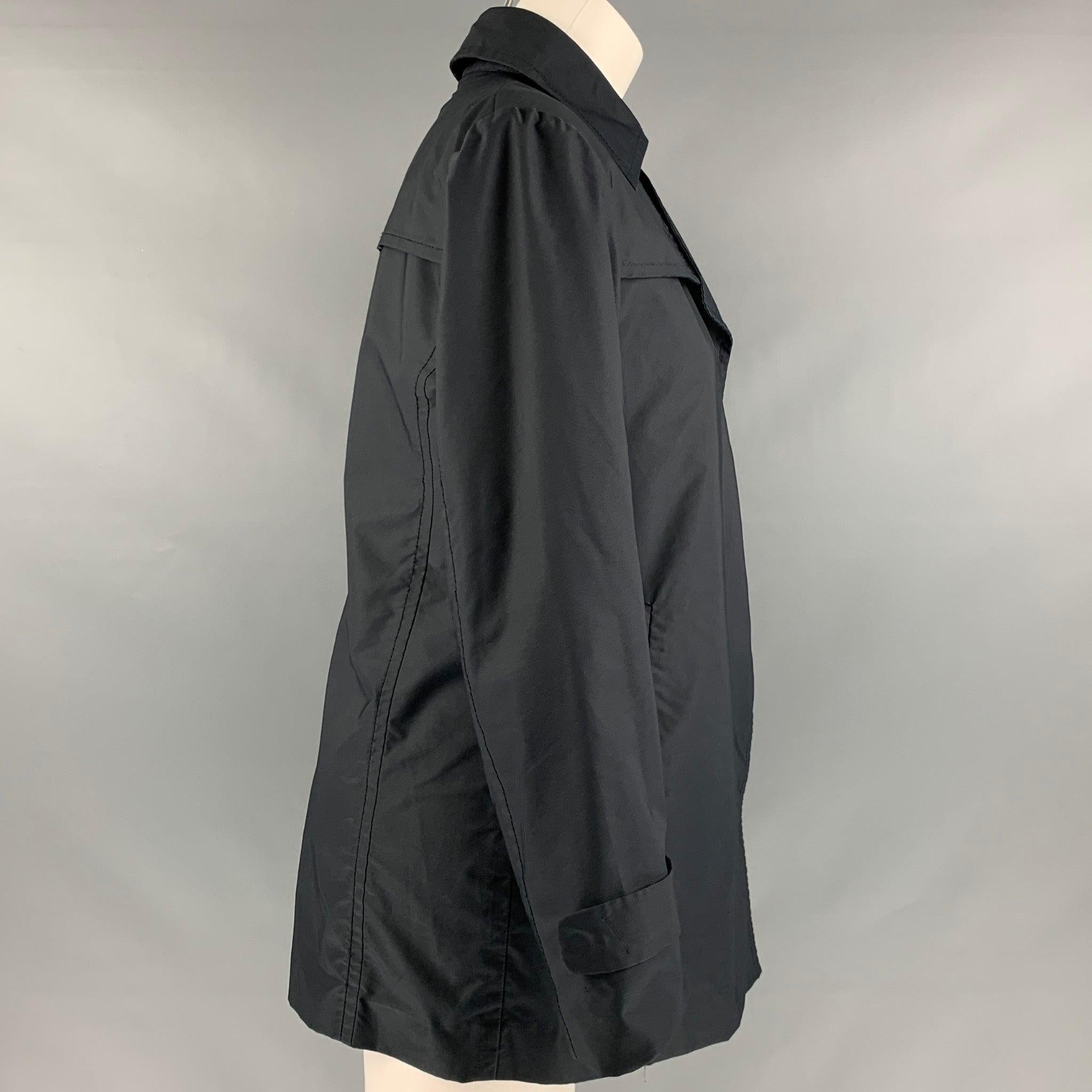 CoSTUME NATIONAL jacket in black polyester blend featuring a single breasted style and a hidden button closure. Made in Italy.Excellent Pre-Owned Condition. 

Marked:   IT 42 

Measurements: 
 
Shoulder: 16 inches Bust: 35 inches Sleeve: 23 inches