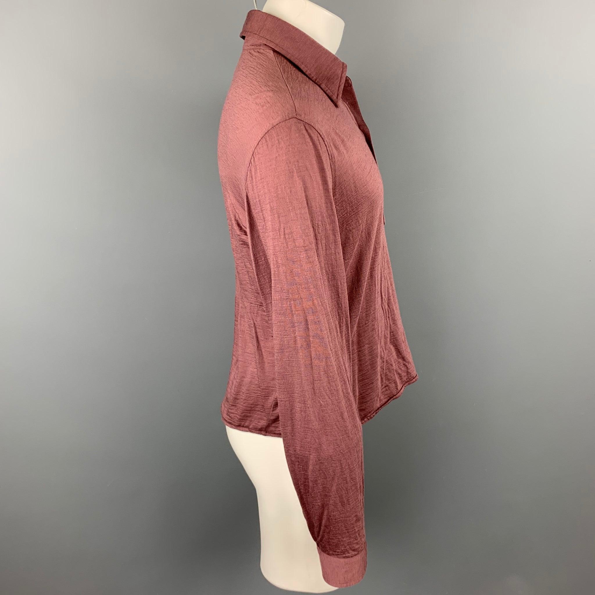 CoSTUME NATIONAL long sleeve polo comes in a mauve wool featuring a spread collar and a buttoned closure. Made in Italy.
Very Good Pre-Owned Condition. 

Marked:   IT 50 

Measurements: 
 
Shoulder: 20 inches 
Chest: 42 inches 
Sleeve: 27 inches