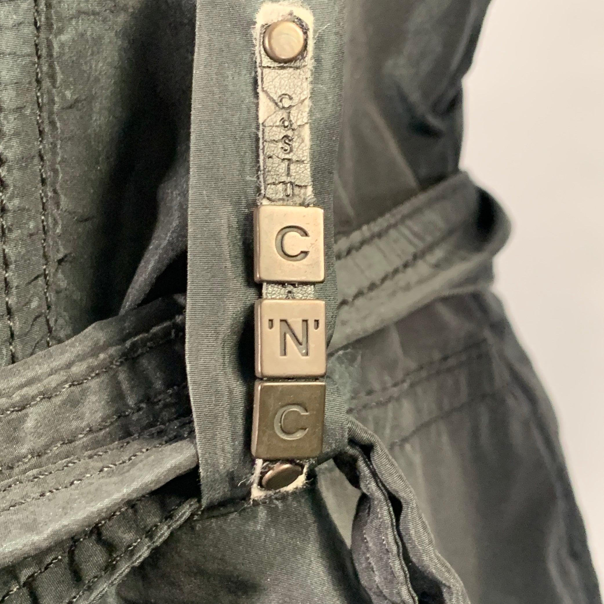C'N'C by CoSTUME NATIONAL jacket
in an iridescent green-black polyester fabric featuring a belted style, multiple utilitarian pockets, and button closure. Made in Italy.Very Good Pre-Owned Condition. Minor signs of wear. 

Marked:   36/50