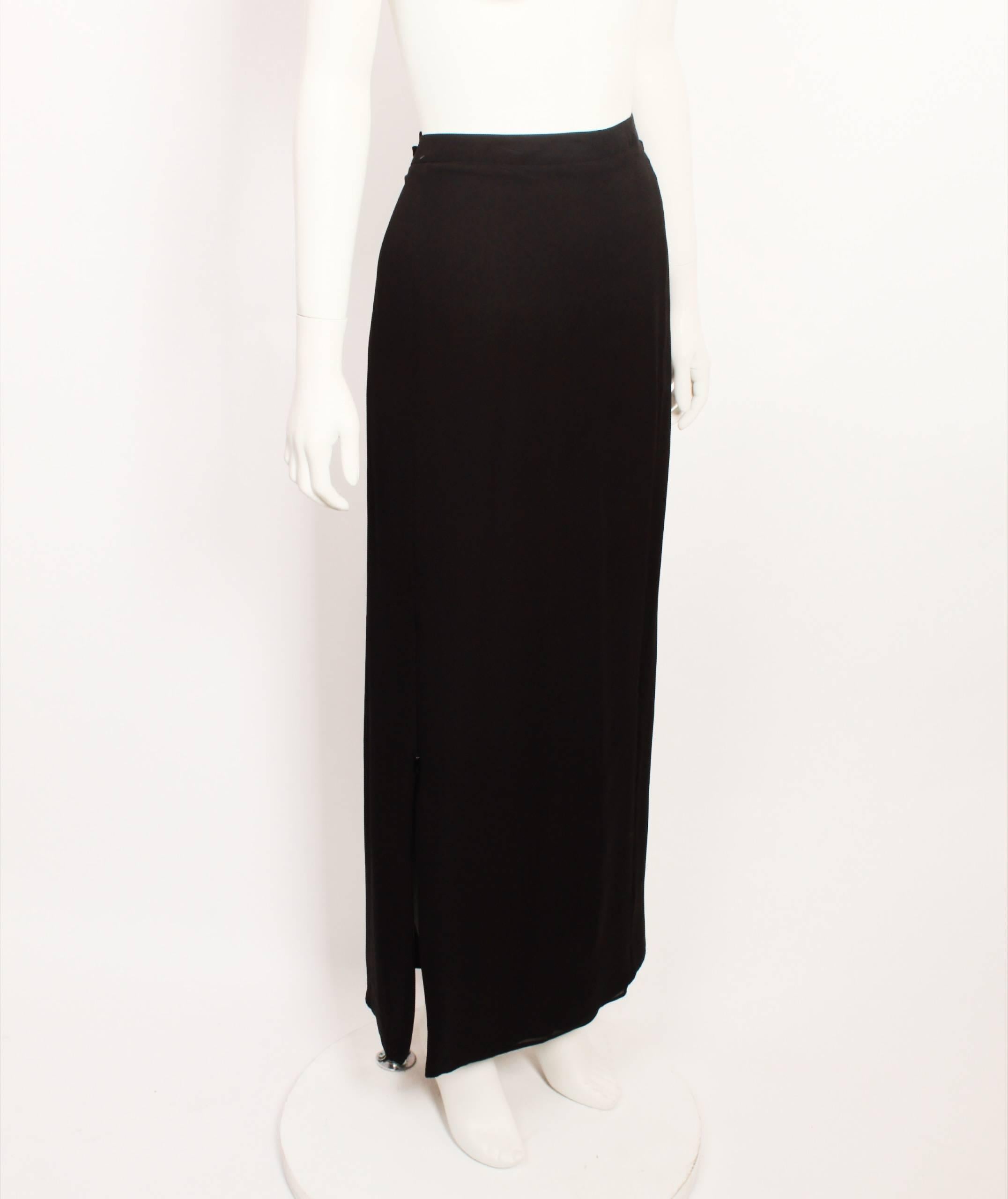 CoSTUME National black silk ankle-length skirt. Clean, strong, minimalist lines. A classic CoSTUME National example. 
Fully lined with back invisible zipper and zipper feature on front,bottom left hand side of skirt. Made in Italy. Size 46.