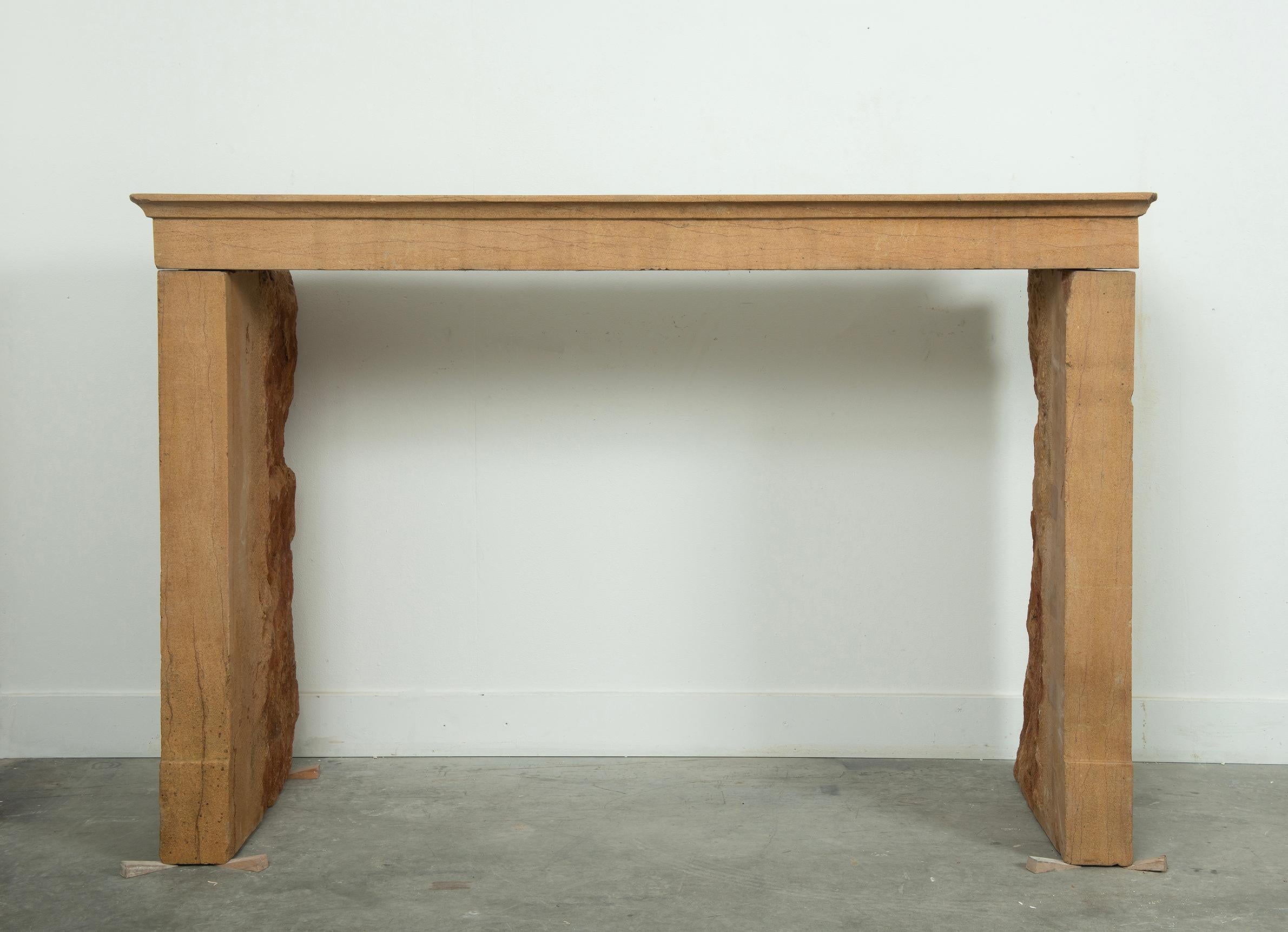 This charming antique limestone fireplace exudes rustic simplicity and warmth, making it an inviting addition to any home. 
Crafted in France, this mantel showcases the natural beauty of limestone with its subtle texture and warm beige tones. 
The