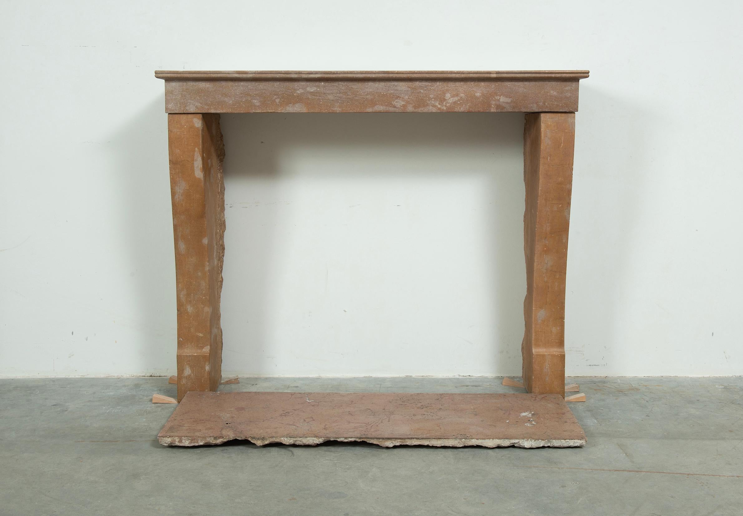 Cosy Colored French Style Limestone Fireplace with Hearth.

This is a nice Dijon Region original 19th century fireplace surround in a Burgundy brownish yellow marble stone with a nice original patina. 
A French cosy country room or a timeless