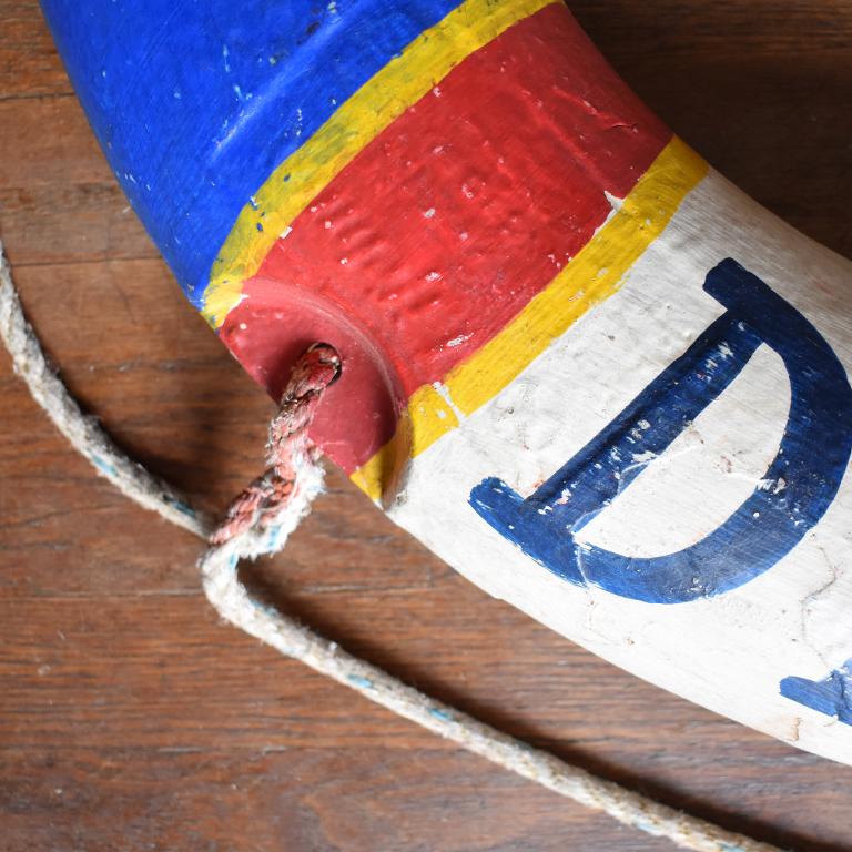 Real authentic life preserver from the French Riviera in France that reads Côte d'Azur on each side. A round life preserver in the colors of France red, white, and blue. With Côte d'Azur painted in navy blue on a white background and blue, red and