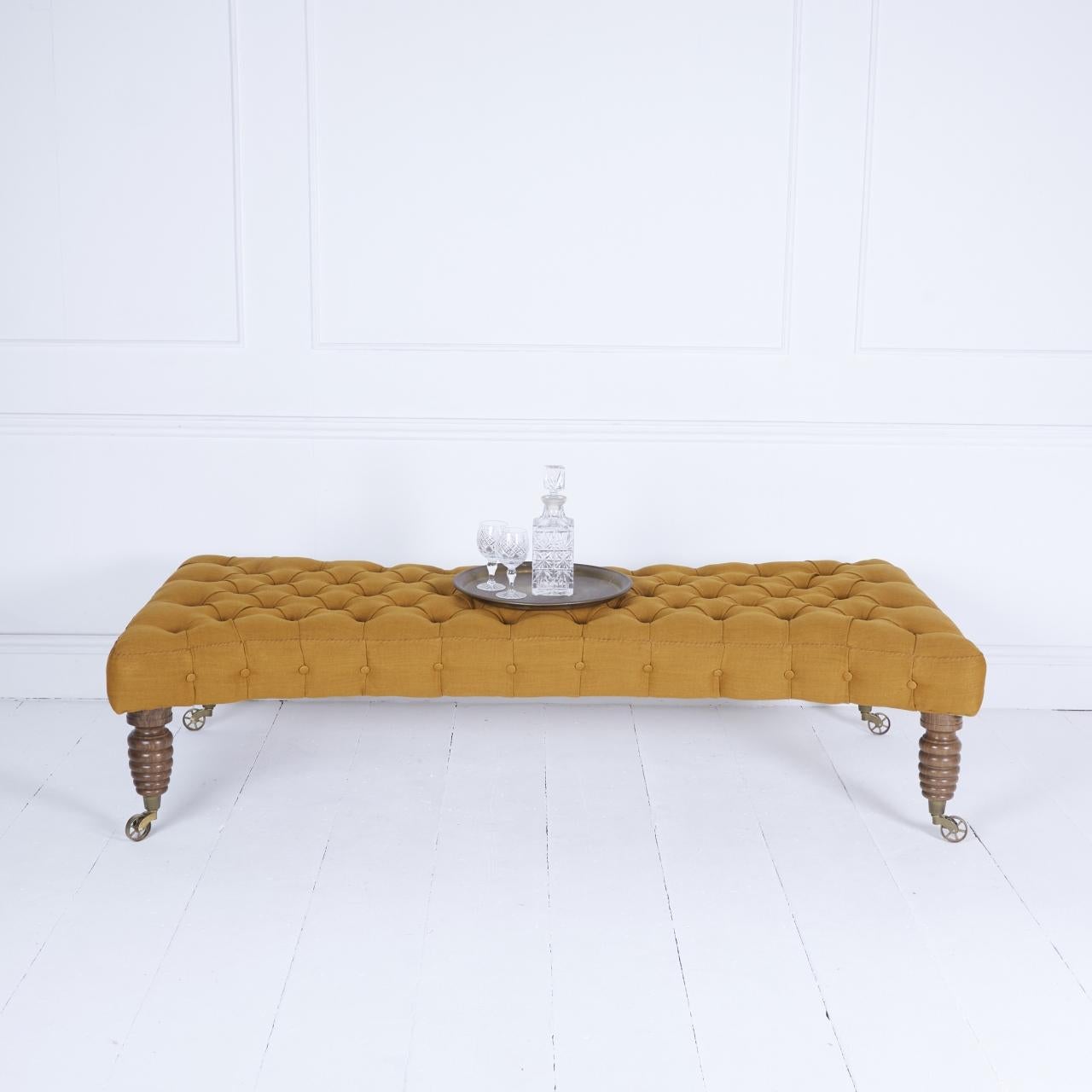 Bespoke made in collaboration with local craft masters this coach-built Cotswold Ash framed stool covered in mustard linen stands on subtly polished Gloucester Walnut legs turned by Dennis French,
92 year old legend turner Dennis French began
