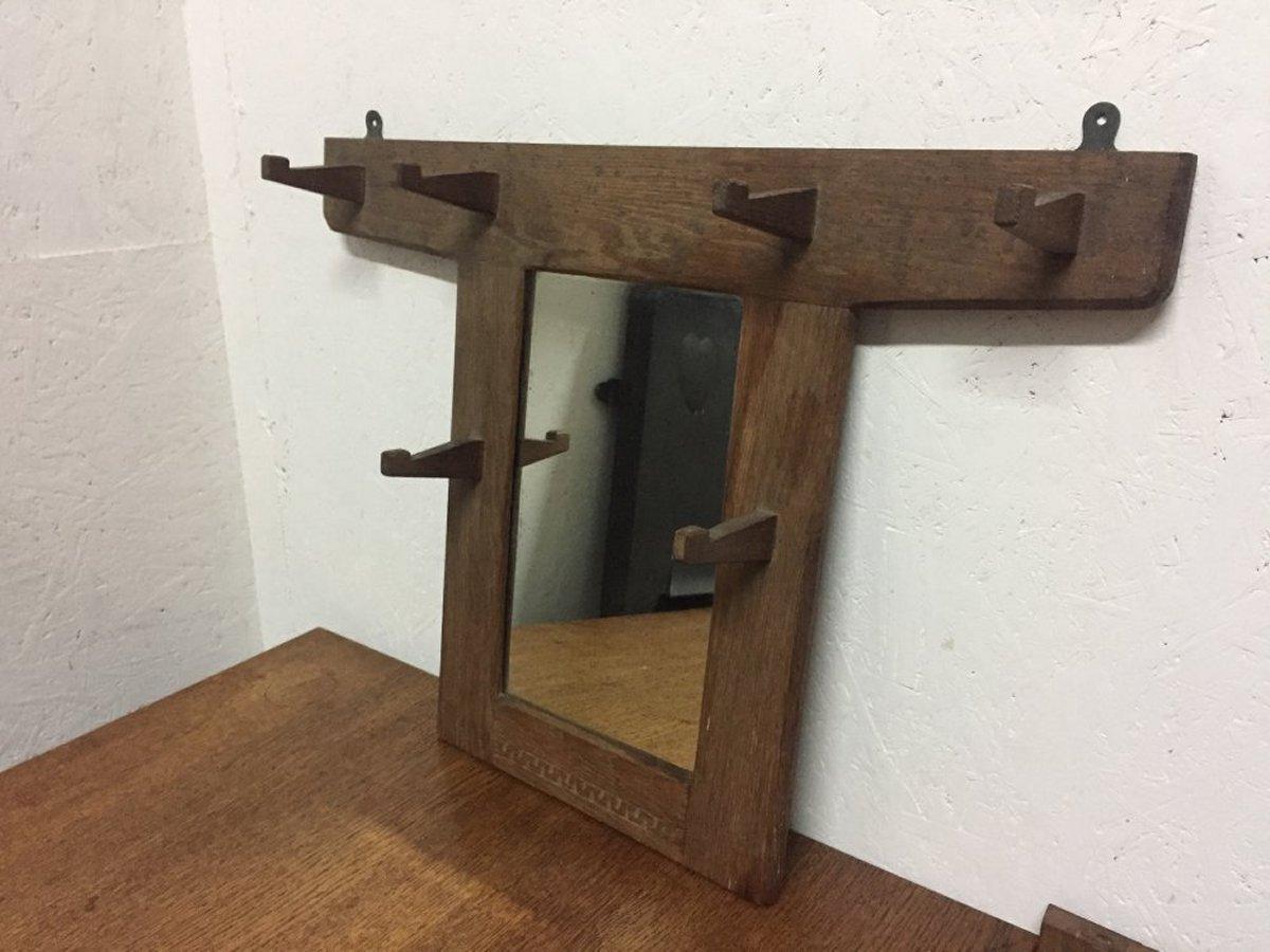 A good quality Cotswold School Arts & Crafts craftsman made oak hall mirror with oak coat hooks, carved details to the base and through tenon details. Attributed to Stanley Webb Davies.
The first image reflects it's true colour, the remaining images