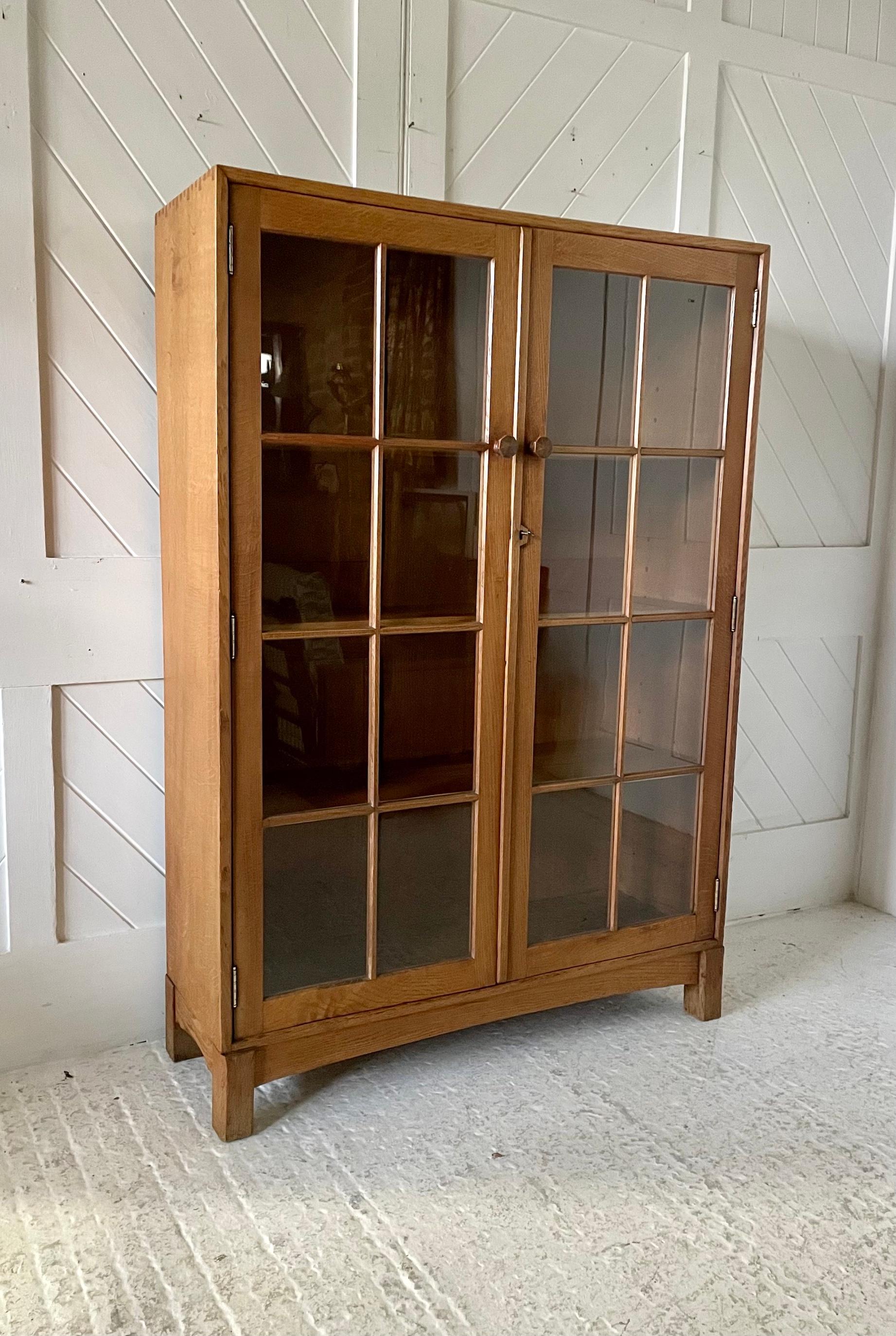 Libreria Cotswold School in Oak

Con fianchi a tavola singola e code di rondine a vista 

Schienale e ripiani regolabili in castagno

Si erge su gambe quadrate smussate con un grembiule ad arco smussato.

Porte vetrate a doppia apertura con maniglie