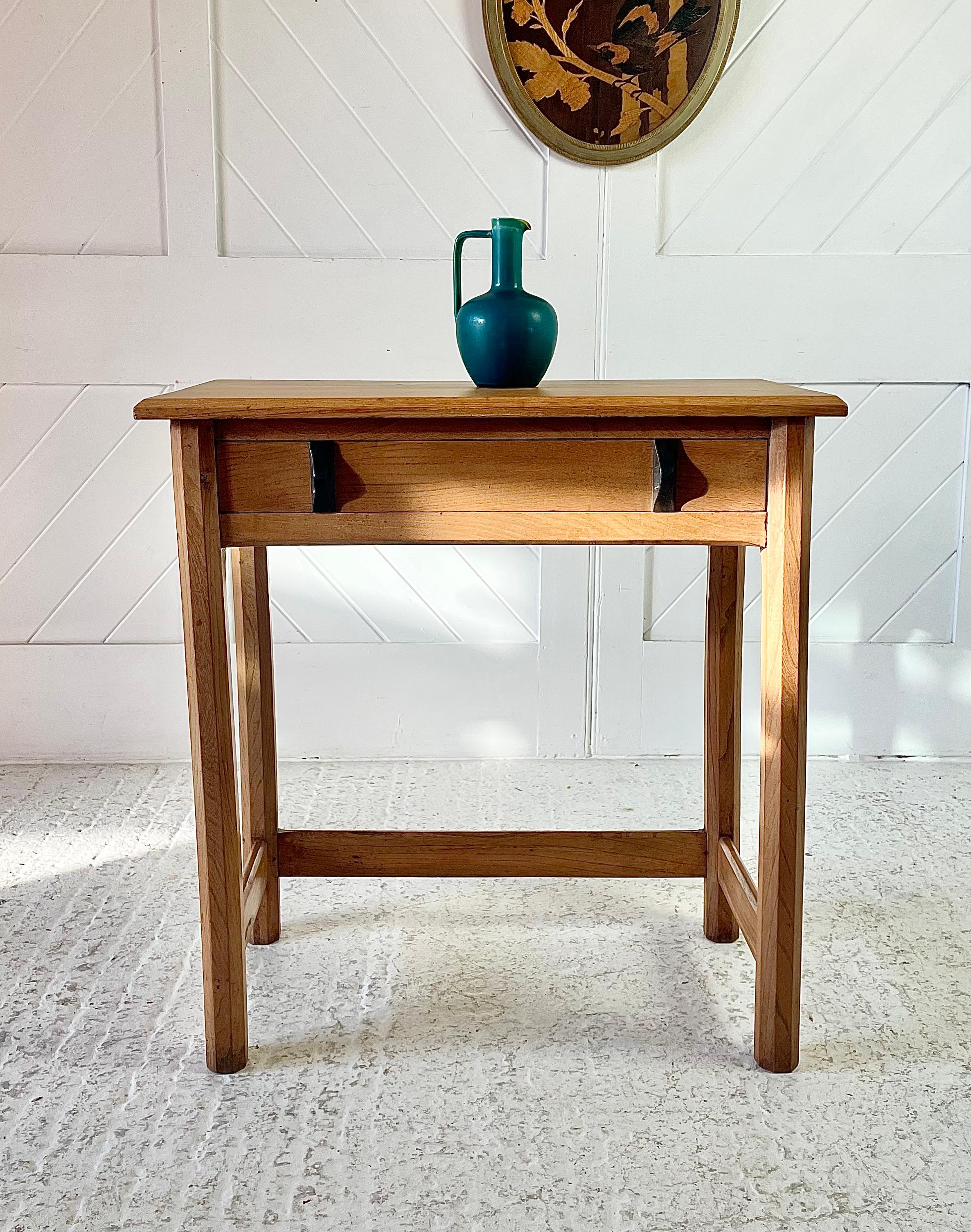 Small Cotswold School writing table in Elm with single drawer lined in cedar wood, ebony handles, raised on hexagonal legs united by chamfered stretchers. 

Circa 1930

Height 76.5cm

Width 72cm

Depth 36cm

Height to drawer 60.5cm

