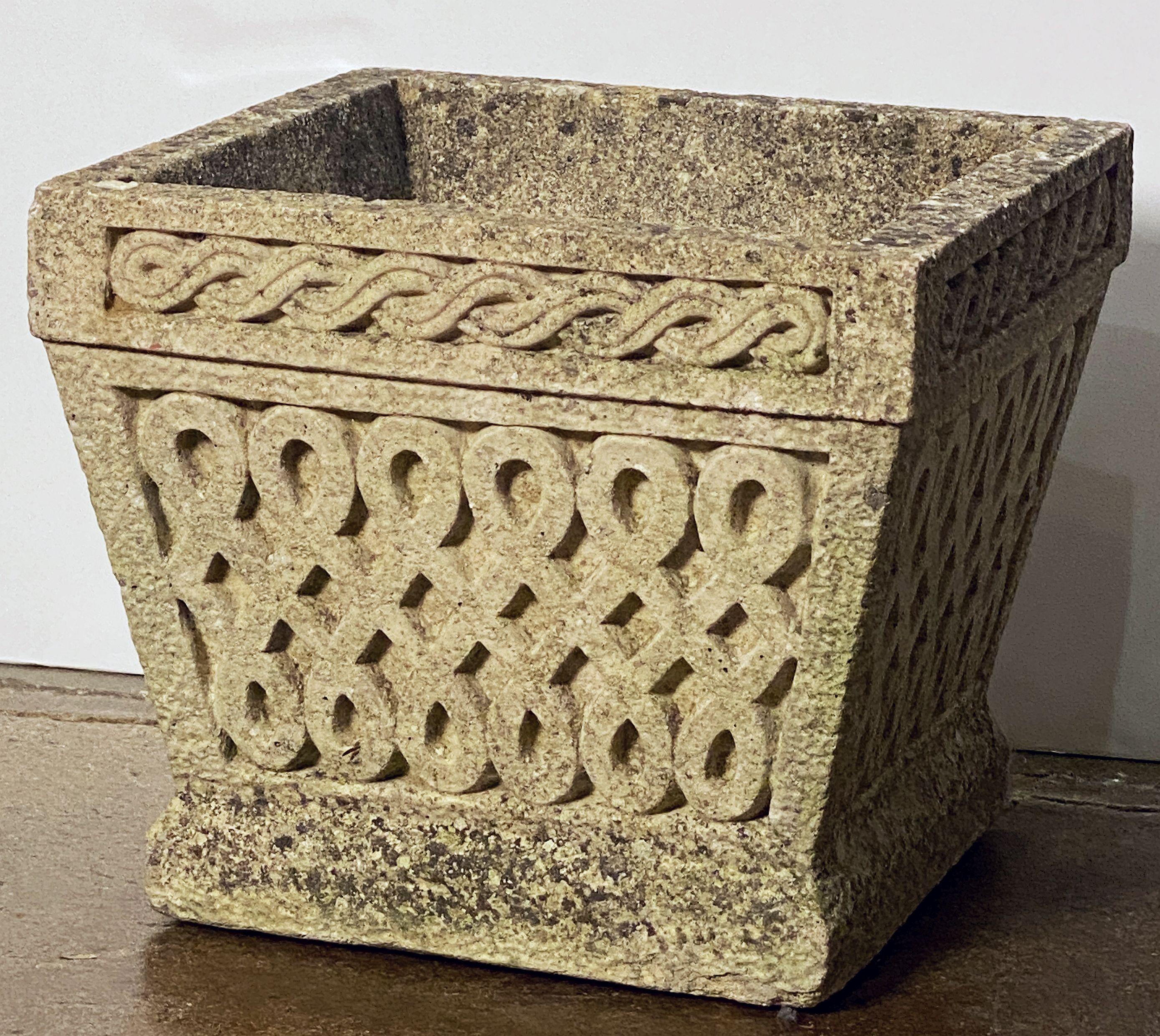 A fine pair of square garden planters or Cotswold Studios pots of composition stone - each featuring a Celtic knot or lattice decorative relief and original, naturally-weathered patina.

Two available - Individually priced - $2895 each planter.