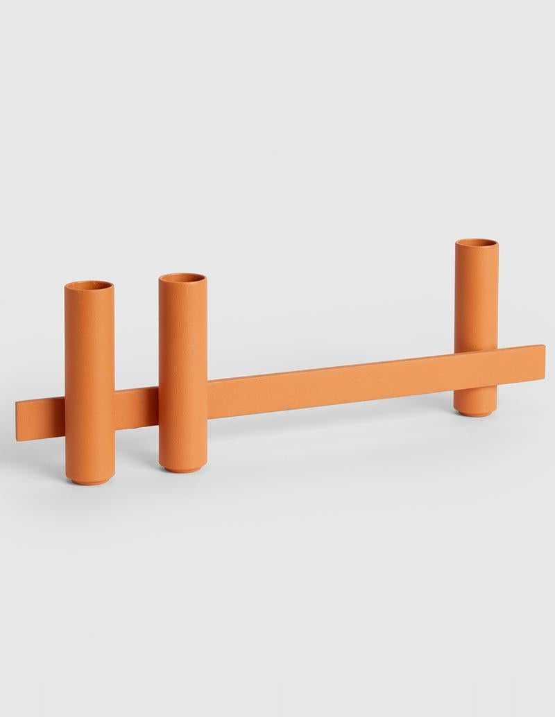 Cotto candle holder by Mason Editions
Dimensions: 31 × 5 × 10 cm
Materials: iron
Colors: black, matte 24K gold, cotto, sage green and light grey.

Consisting of a longitudinal metal bar supporting cylindrical elements on both sides, Petit is an