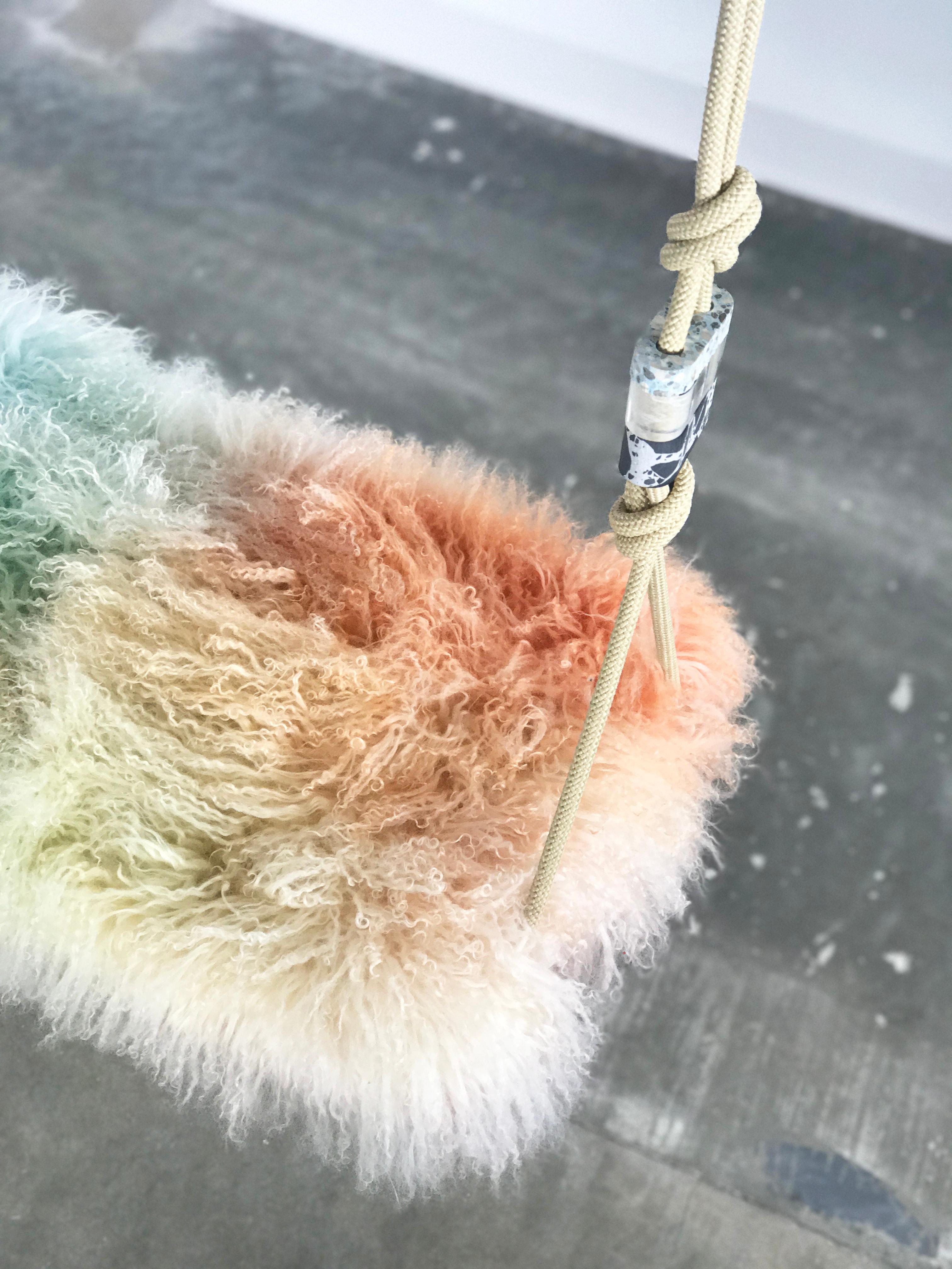 The Cotton Candy swinging bench is a playful indoor swing for two featuring a Tibetan Lamb cushion, colorful accessory cord, a Lucite base and Lucite accessories. Featured here is a fun, multi-color Tibetan Lamb, however, there are a variety of