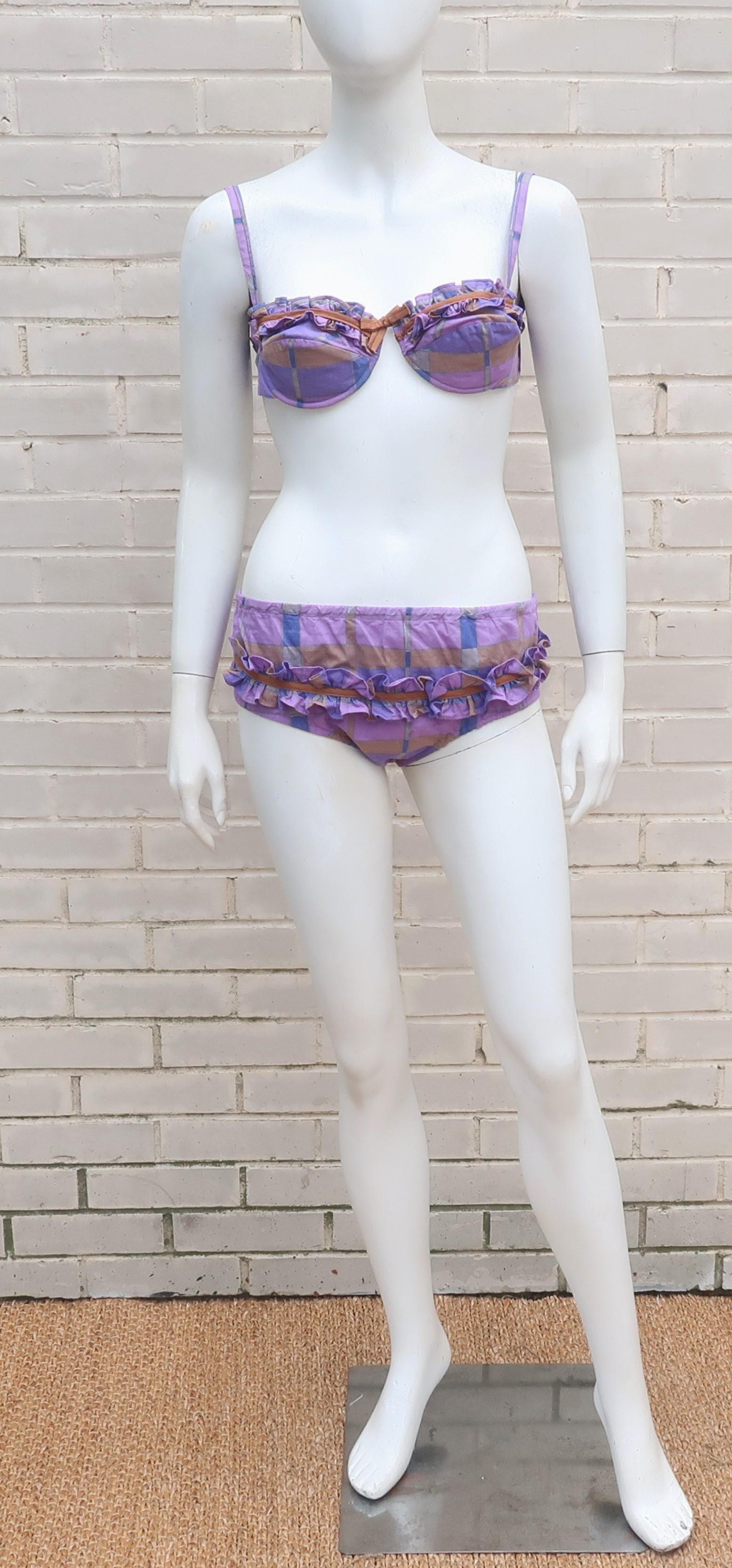 Gidget alert!  1960's two piece bikini in a comfortable cotton purple and cognac brown plaid with ruffled details.  The top is constructed with molded underwire cups lined with built-in pads, adjustable shoulder straps and elasticized hook at the