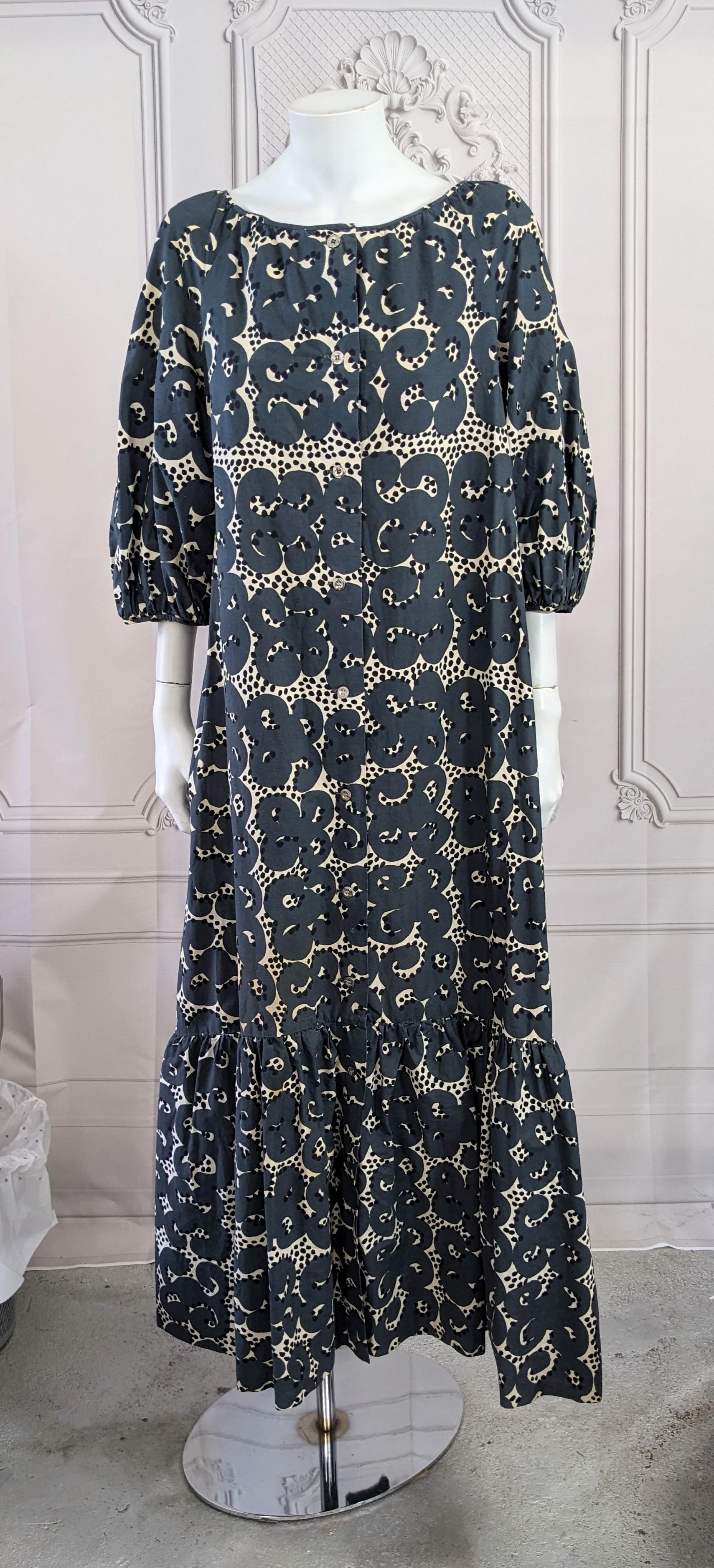 Charming Cotton Poplin Marimekko Maxi Ruffle Dress from the 1970's. Super graphic on grey ground with ruffled hem and puffed sleeves.
Metal button front closure down front. Hem ruffle and sleeves are backed in a stiff linen to maintain the fullness