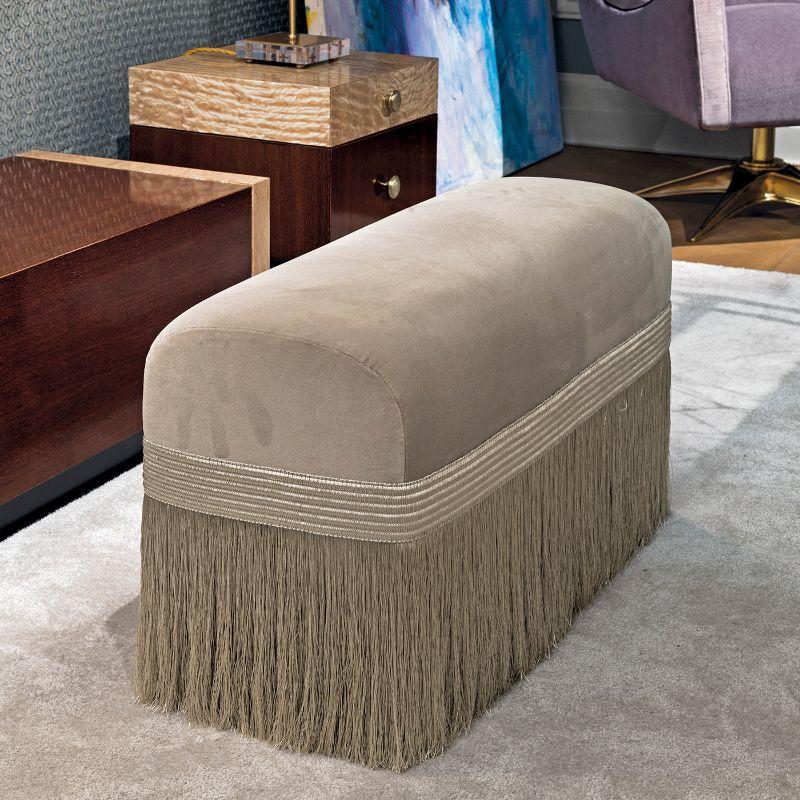 Distinguished by an alluring ensemble of long, cascading fringes, this magnificent pouf will embellish both modern and classic interiors thanks to its timeless elegance. Upholstered with a beige cotton velvet cover, it will make a refined accent to