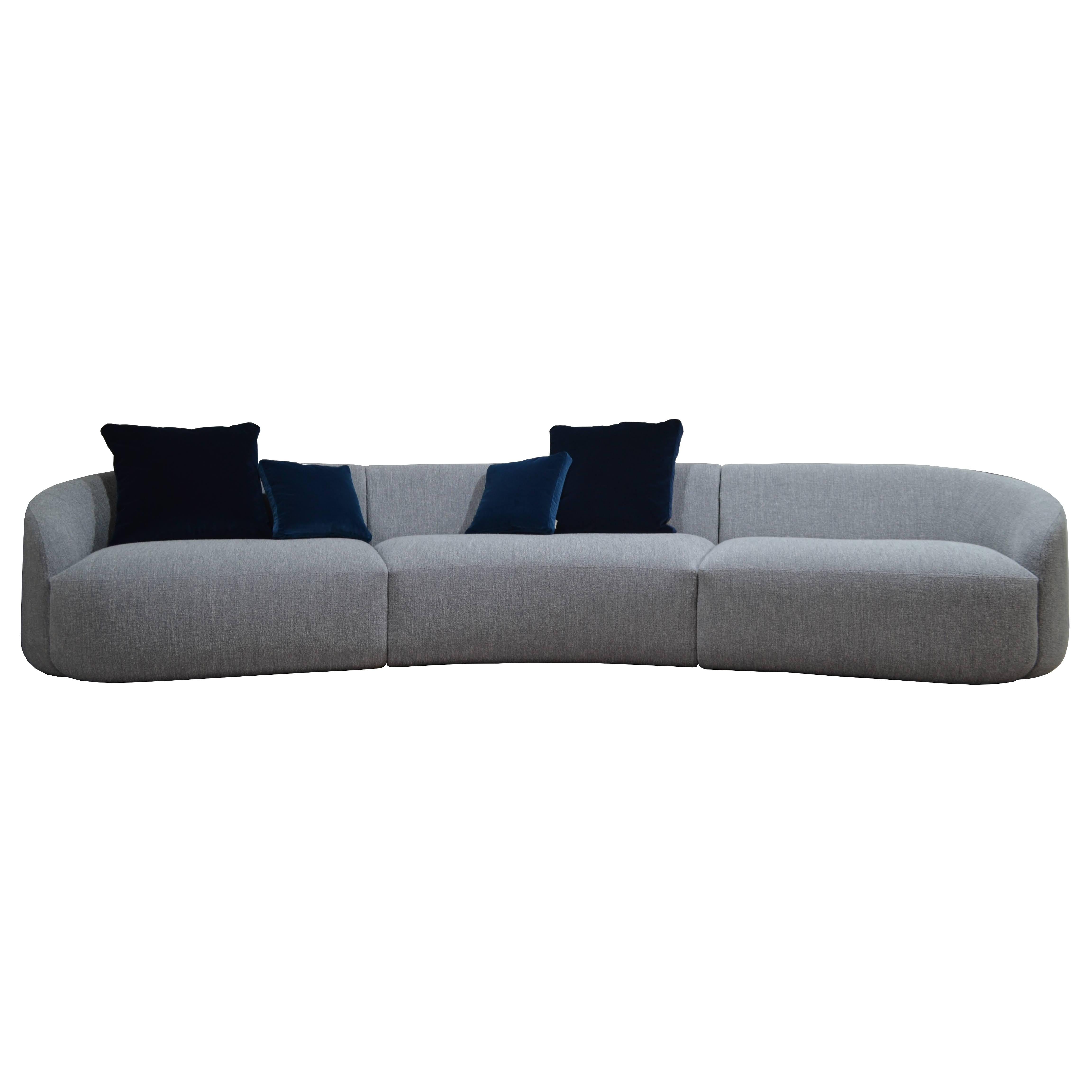 The rounded, curved shape, is crafted into the unique and original design of this well-proportioned and visually distinctive sofa series, available in custom sizes, ensuring intimacy and convivial socialisation in any interior. Upholstery in your