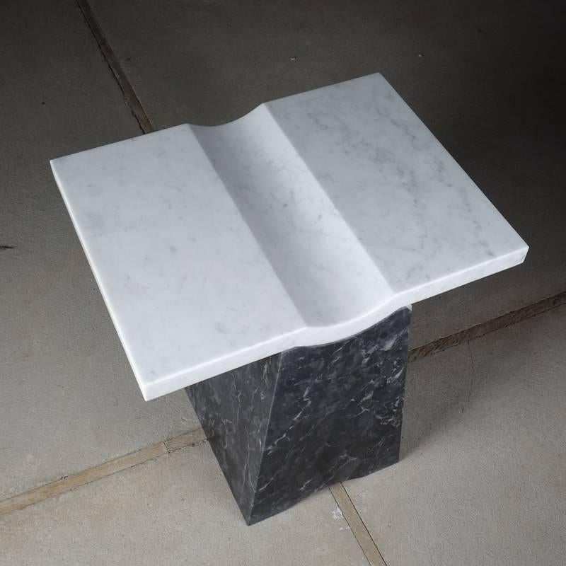 The distinguishing feature of the Coulee side table is the subtle recessed curve on the middle of flat tabletop. The recessed curve implies a gentle gesture for many different ways of uses.

Materials: Bardiglio nuvolato, Bianco Carrara Marble.