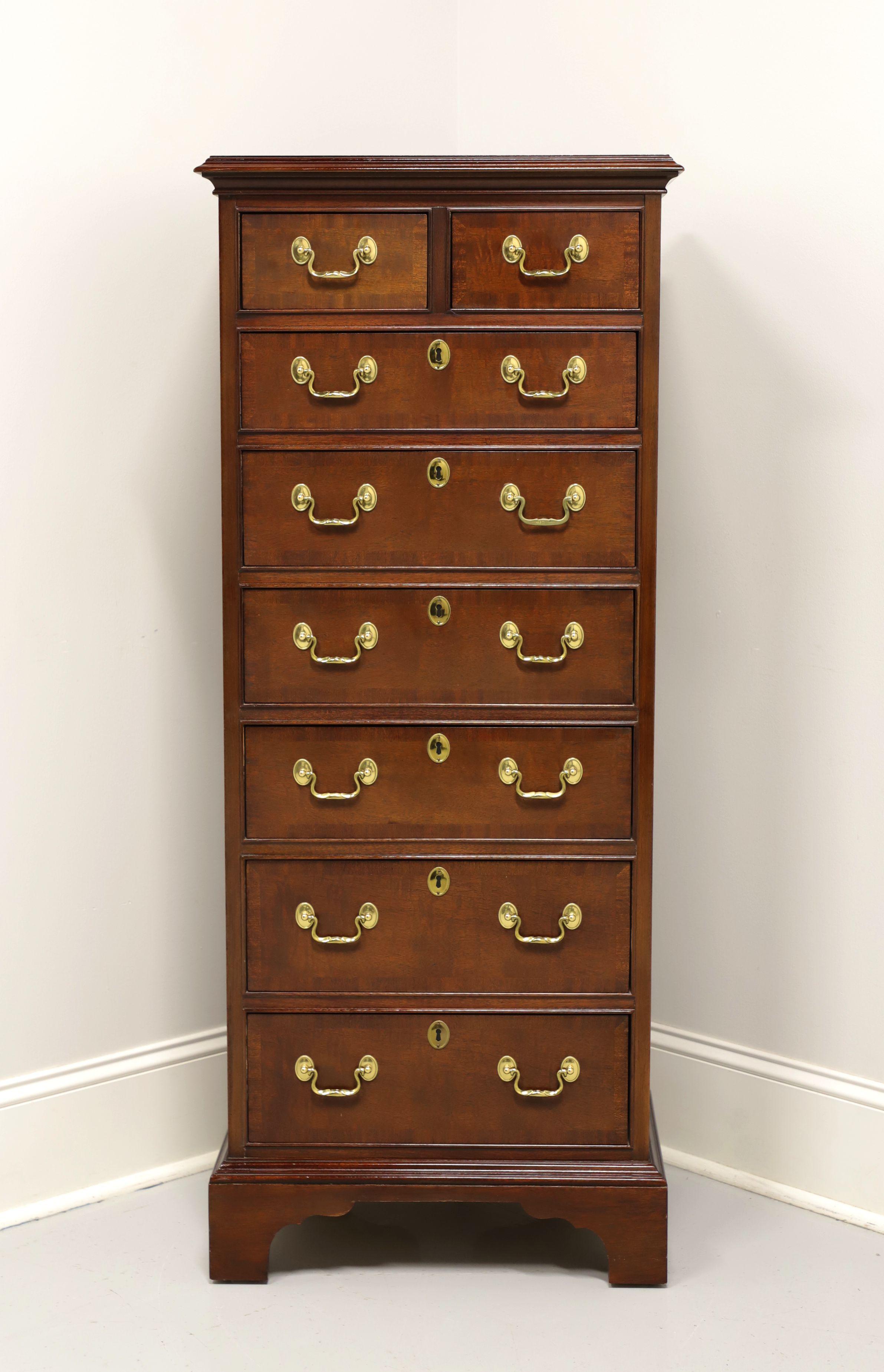 A Chippendale style lingerie chest by Councill Craftsmen. Solid mahogany with banded drawer fronts, brass hardware and bracket feet. Features two smaller over six larger dovetail drawers with faux keyhole escutcheons. Made in North Carolina, USA, in
