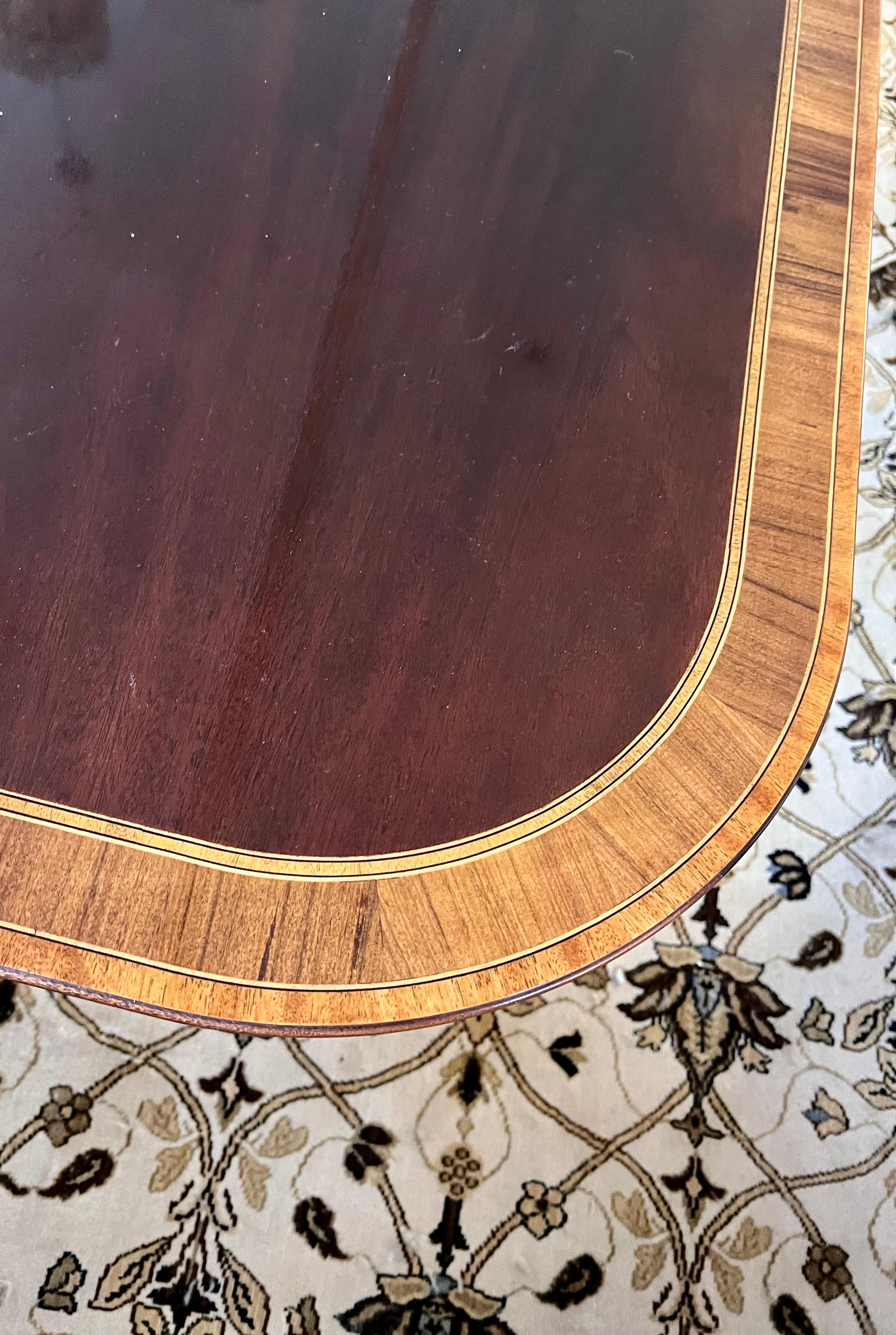 Grand flame mahogany banded inlay dining table that features double pedestal as well as two 20