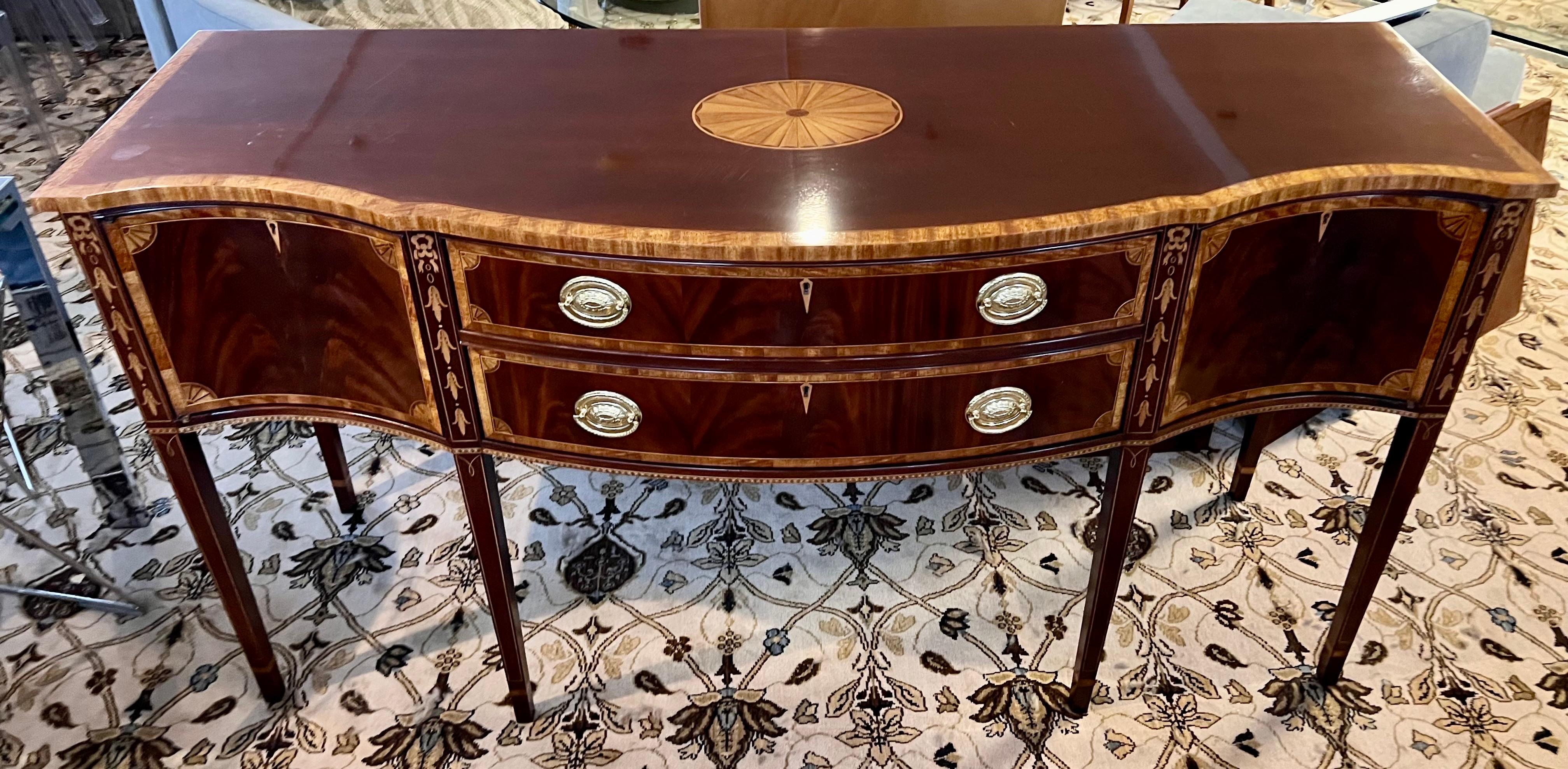 Elegant and exquisite flame mahogany Councill Craftsman buffet has multiple drawers and compartments and features gorgeous lines and the coveted bell flower inlay.  It features lockable drawers/compartments with keys as well as the felt lined drawer