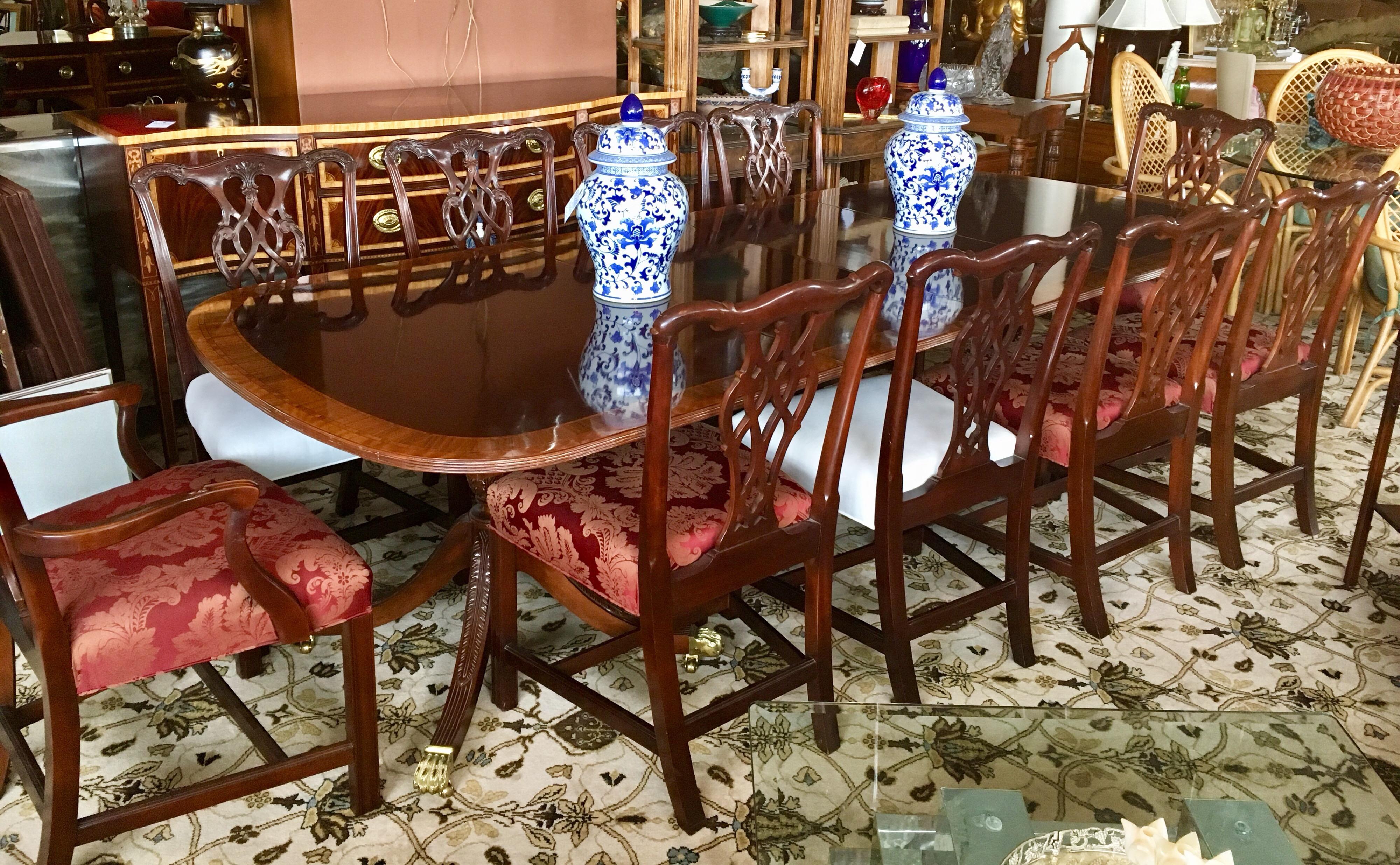 Stunning Councill craftsman mahogany inlay dining room table with twelve matching chairs featuring two different upholstered seat fabrics. There are three twenty inch leaves that expand the table to one hundred and thirty two inches.