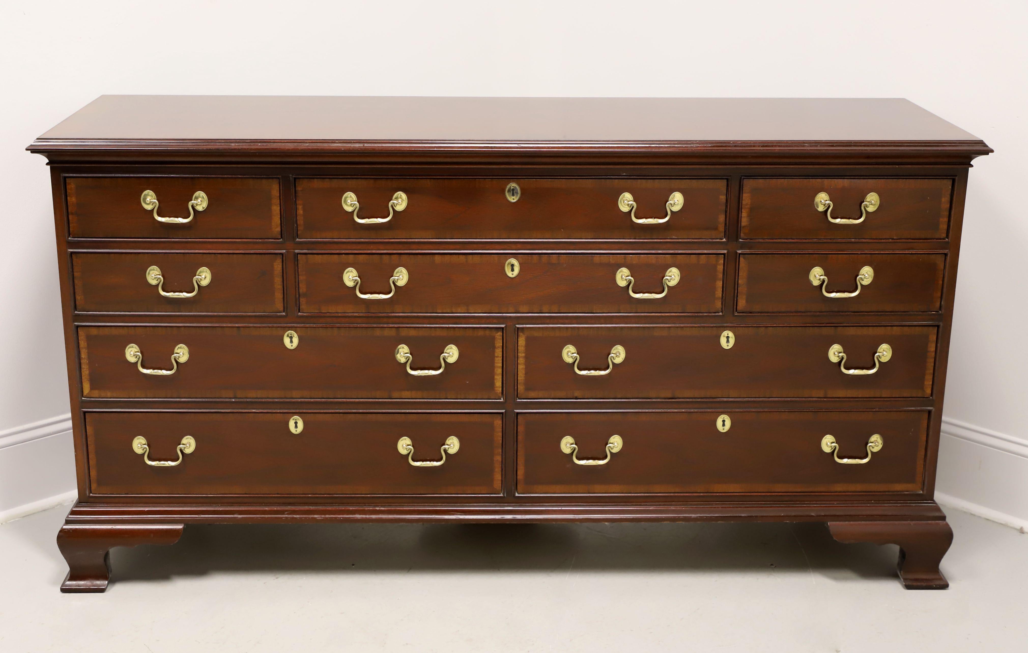 A Chippendale style triple dresser by Councill Craftsmen. Solid mahogany with brass hardware, banded top with ogee edge, banded drawer fronts, and ogee bracket feet. Features ten various size drawers of dovetail construction, six with faux keyhole
