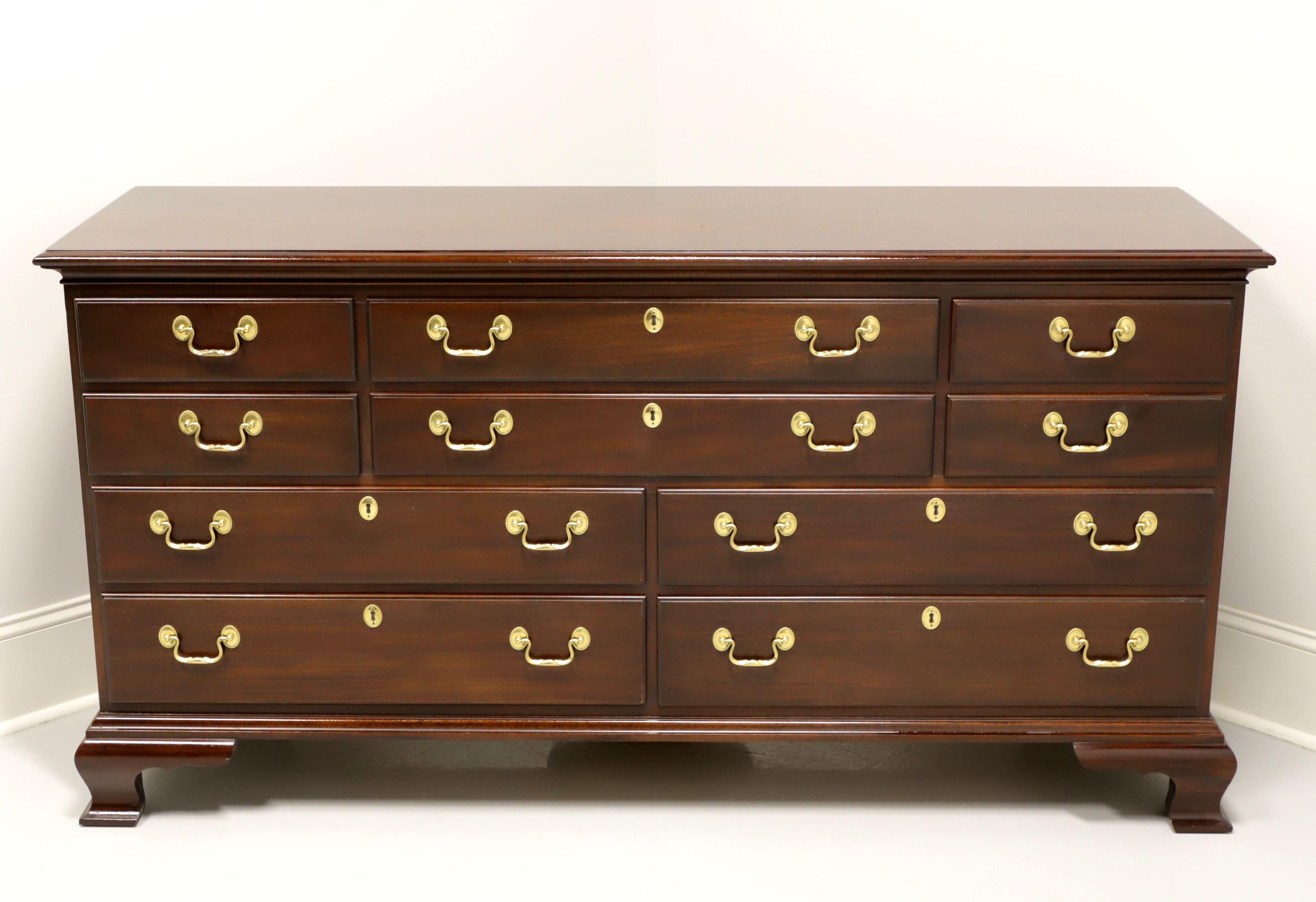 A Chippendale style triple dresser by Councill Craftsmen. Solid mahogany with brass hardware and ogee bracket feet. Features ten various size drawers of dovetail construction, four with faux keyhole escutcheons and top right drawer having fixed