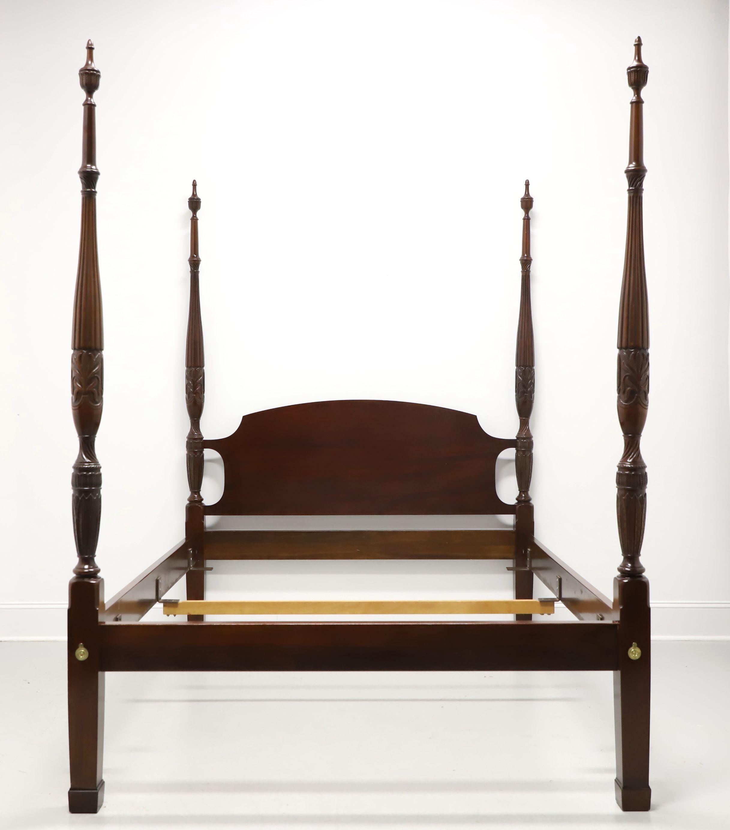 A Traditional Chippendale style queen size poster bed by Councill Craftsmen. Mahogany with solid headboard, four rice carved posts with finials, brass hardware, bolt held side rails with metal bracers and one center wood slat for providing mattress