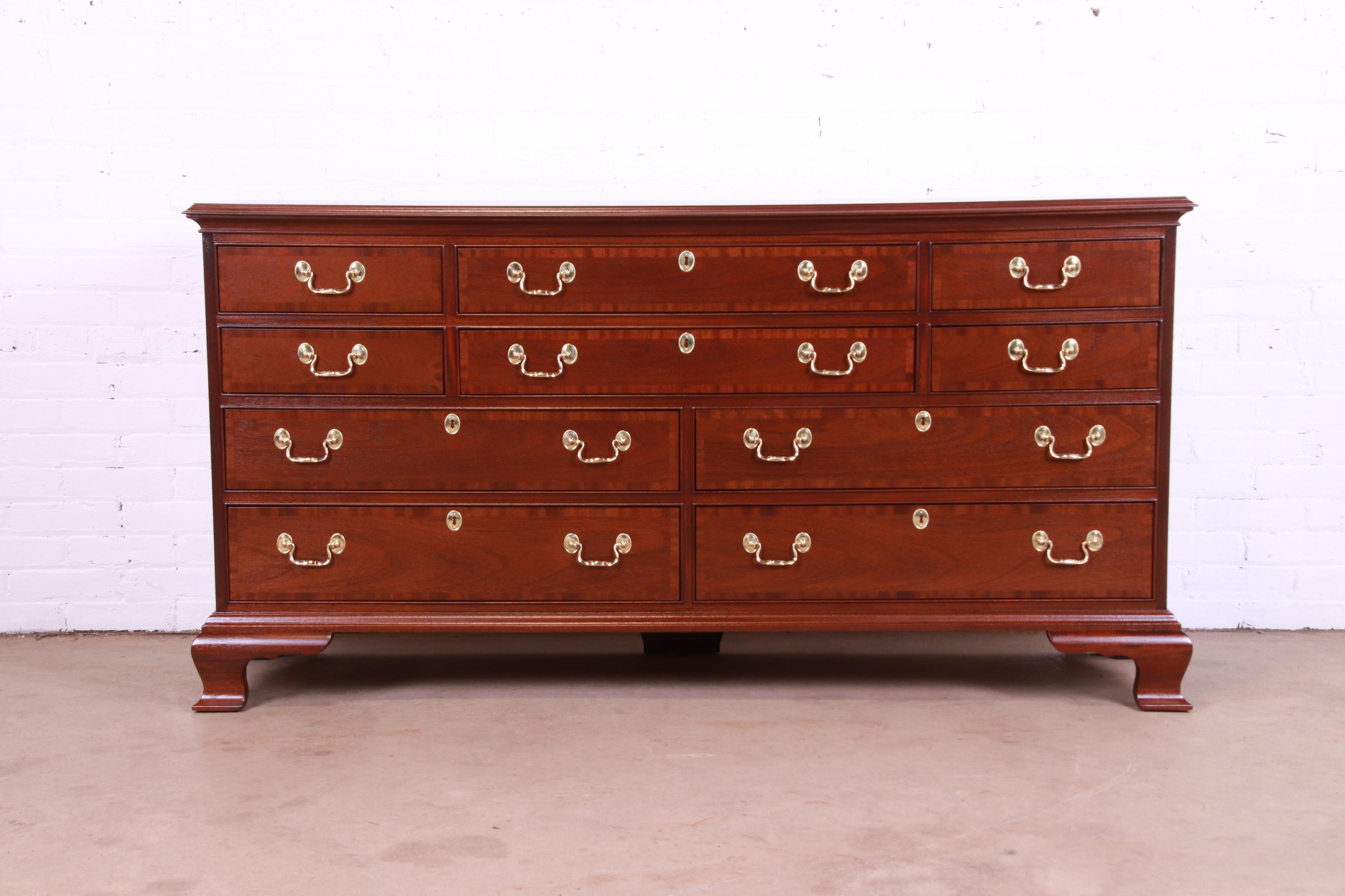 An exceptional Georgian or Chippendale style ten-drawer dresser or credenza

By Councill Furniture

USA, Circa 1980s

Banded mahogany, with original brass hardware.

Measures: 66.5