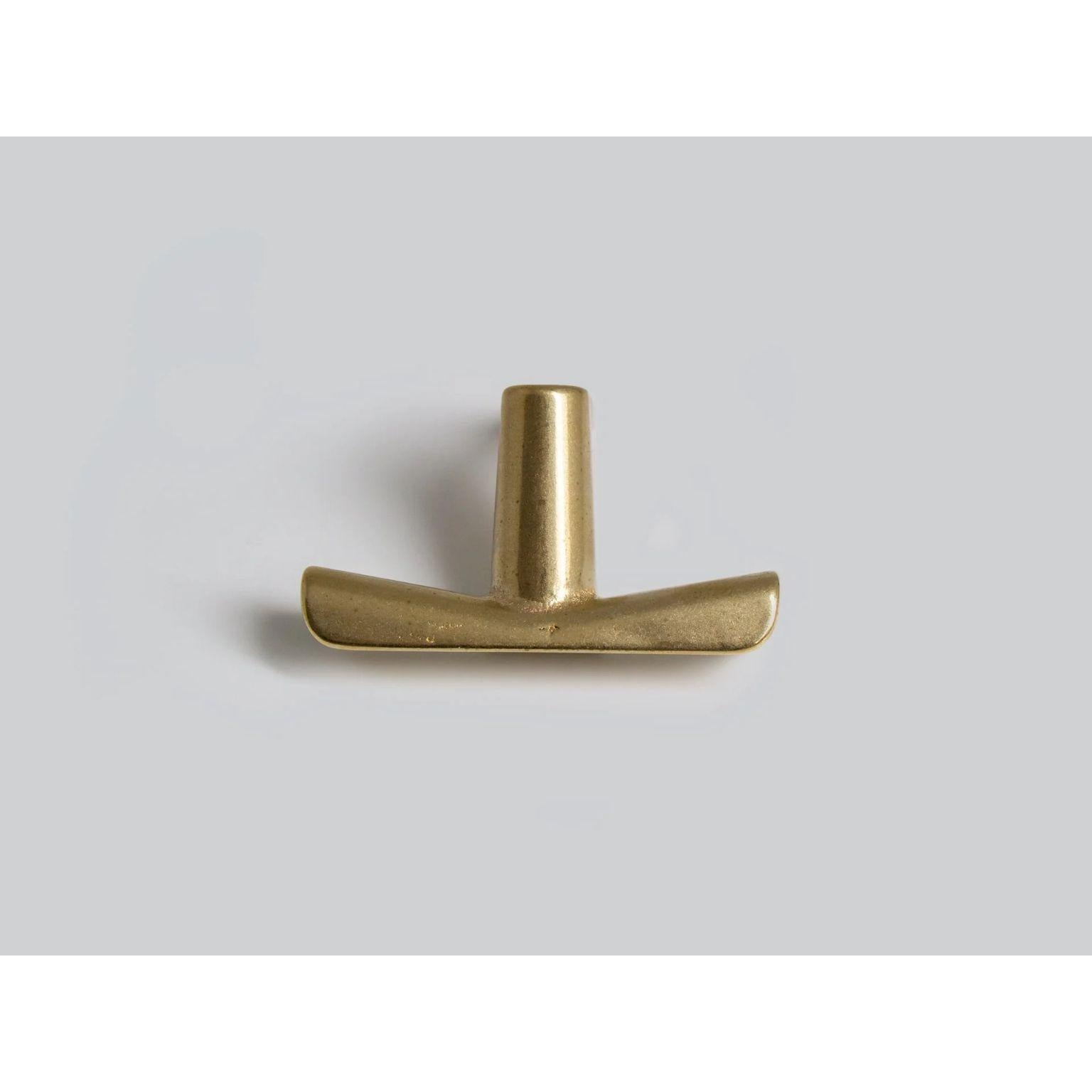 Brass Counter Hook by Henry Wilson
Dimensions: W 6 x D 4 x H 5 cm
Materials: Brass

Designed for hanging bags and coats under bar counters. 
Each piece is sand cast in brass and rumble finished.
They are manufactured in small batches meaning slight