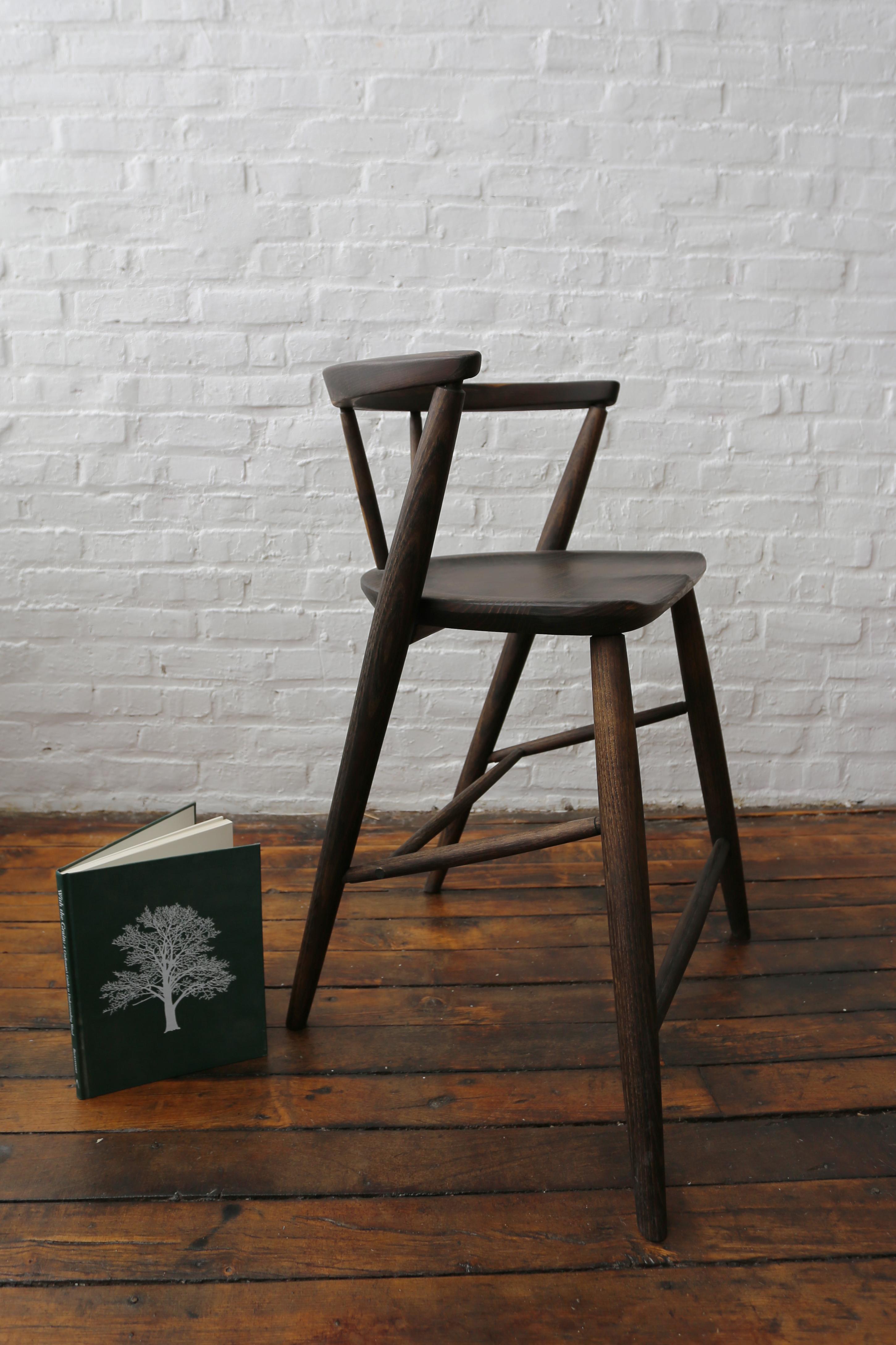 In our newest design we took the essence of our dining chair and adapted it into a counter height stool. The design draws the eye up the long tapered leg, to the soft curve of the back, giving a striking and sultry effect. The foot rest and arm