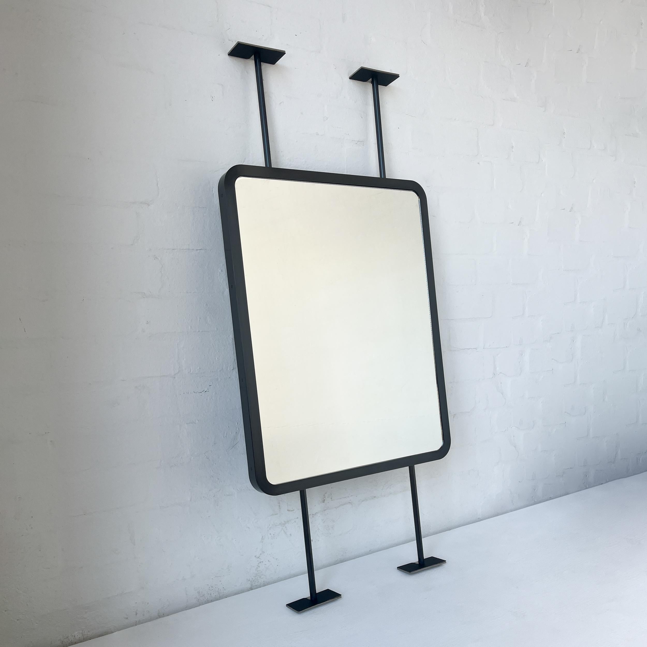 Contemporary countertop to ceiling attached Quadris™ rectangular mirror with a handcrafted blackened stainless steel full frame. Designed and made in London, UK. This mirror is fully customisable.

Dimensions:

H 61cm x W 48.3cm x D 3cm (Drop