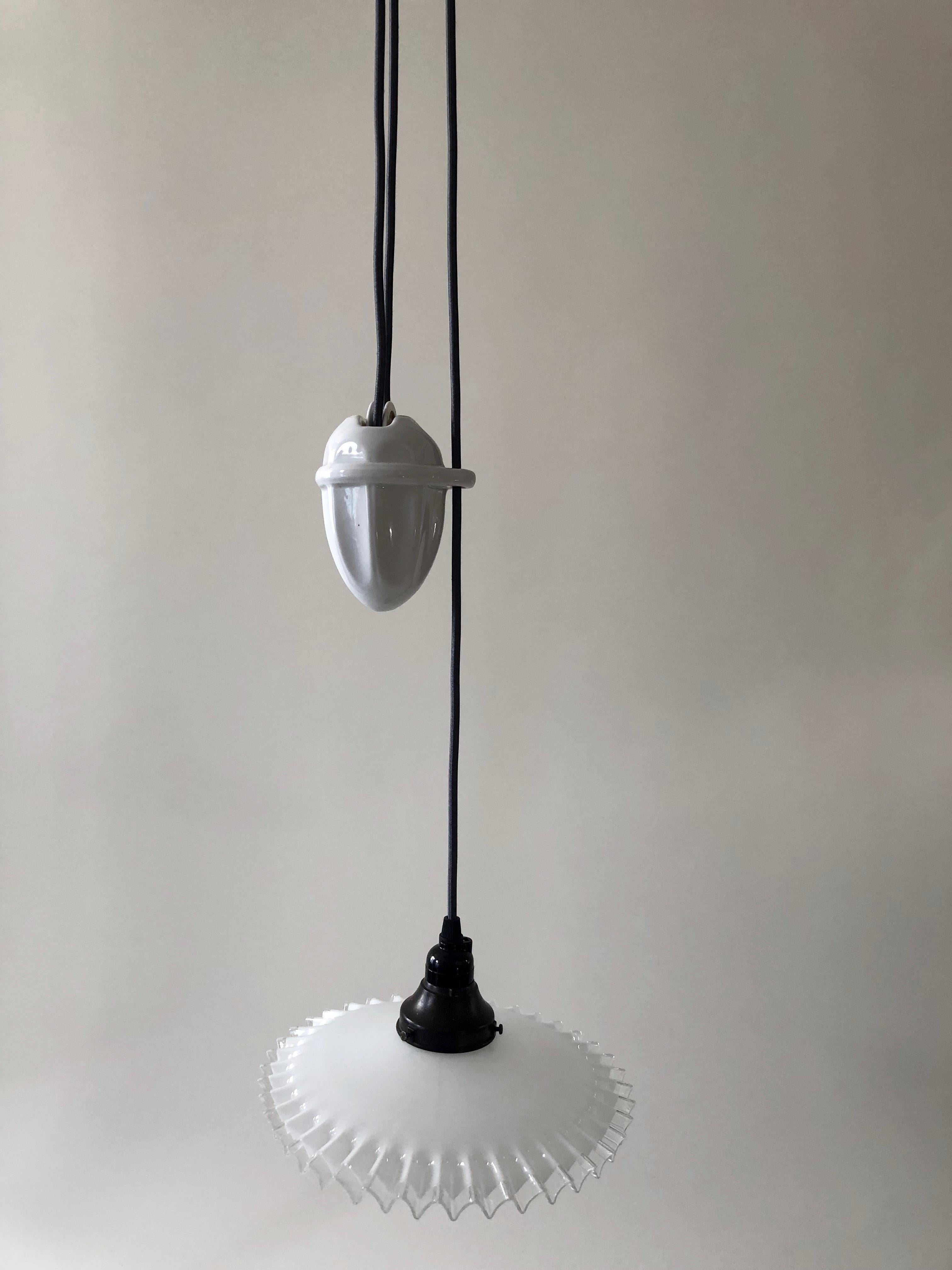 A beautiful counterweight pendant lamp from circa 1900. Originating in Austria, in the K and K Monarchy, it has a patent dating
from the industrial revolution. The lamp is made up of two pieces of porcelain, the upper piece attaches to the ceiling