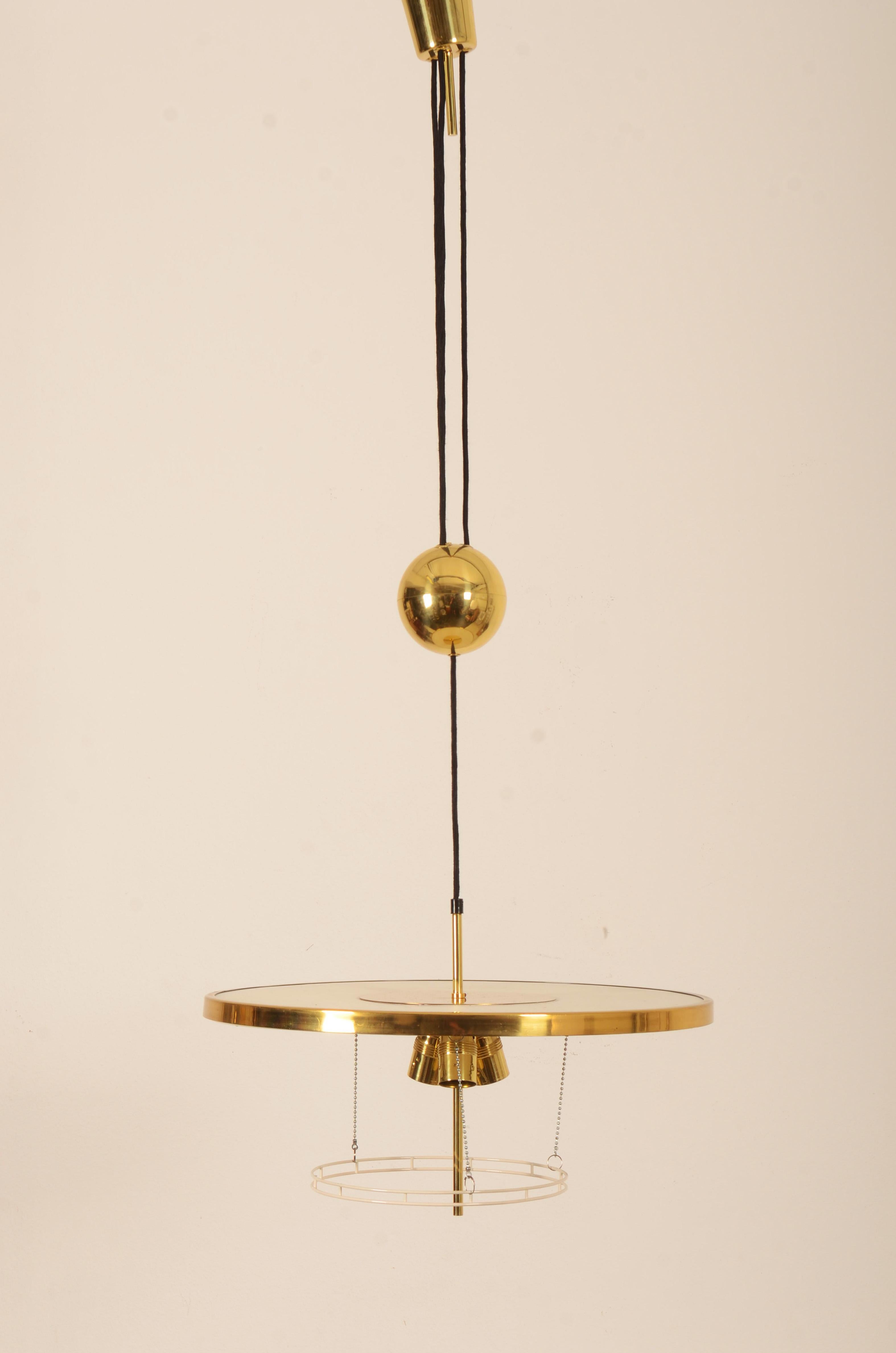 A height adjustable brass counter balance pendant lamp by J.T. Kalmar manufactured in midcentury in 1950s and designed by Adolf Loos. Fitted with three E27 sockets. The lamp is fully restored with new electric.
 