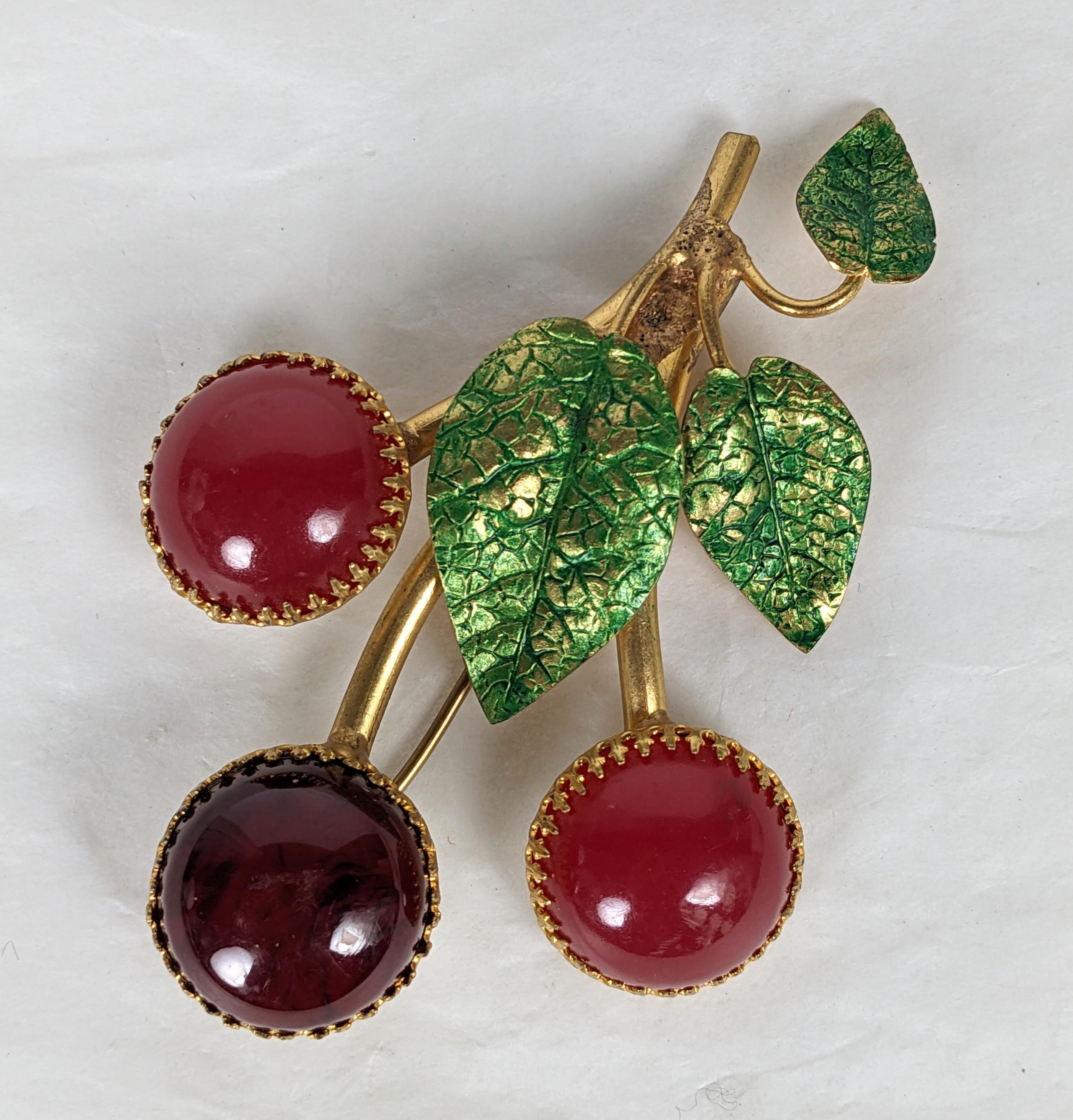 Rare Countess Cis Bakelite Cherry Brooch from the 1960's. Designed with a bakelite cherries with hand enamel leaves set into gilt bronze filigree settings. Unsigned but recognized as a Countess Cis design. French closure. 1960's France. 3
