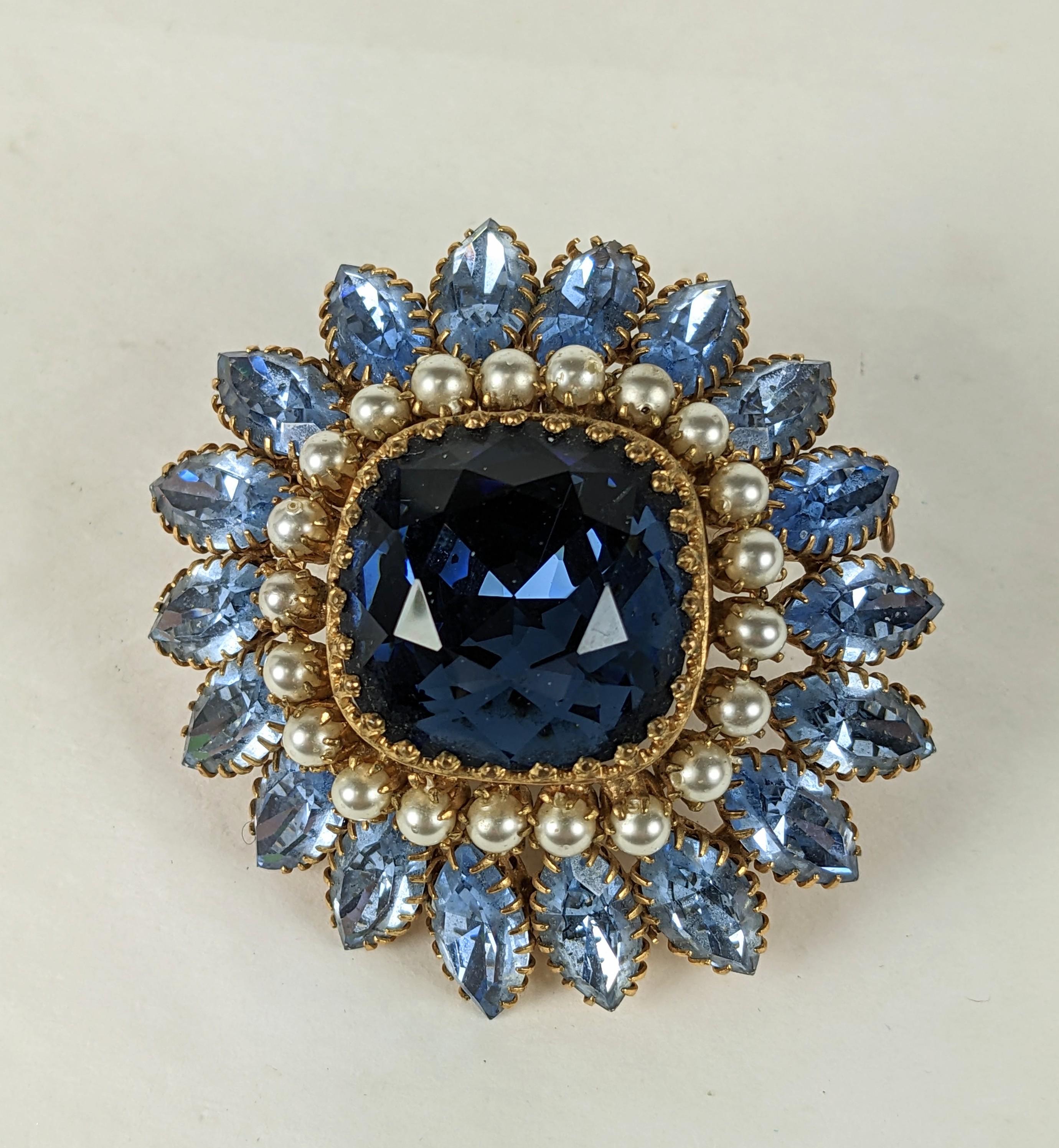 Countess Cis brooch of cushion cut faux sapphire, pale aquamarine faceted marquises and faux pearls. Set in rich gilt plate with signature Countess Cis multi prong eyelash settings.
Unsigned. Excellent Condition, L 2 2/8