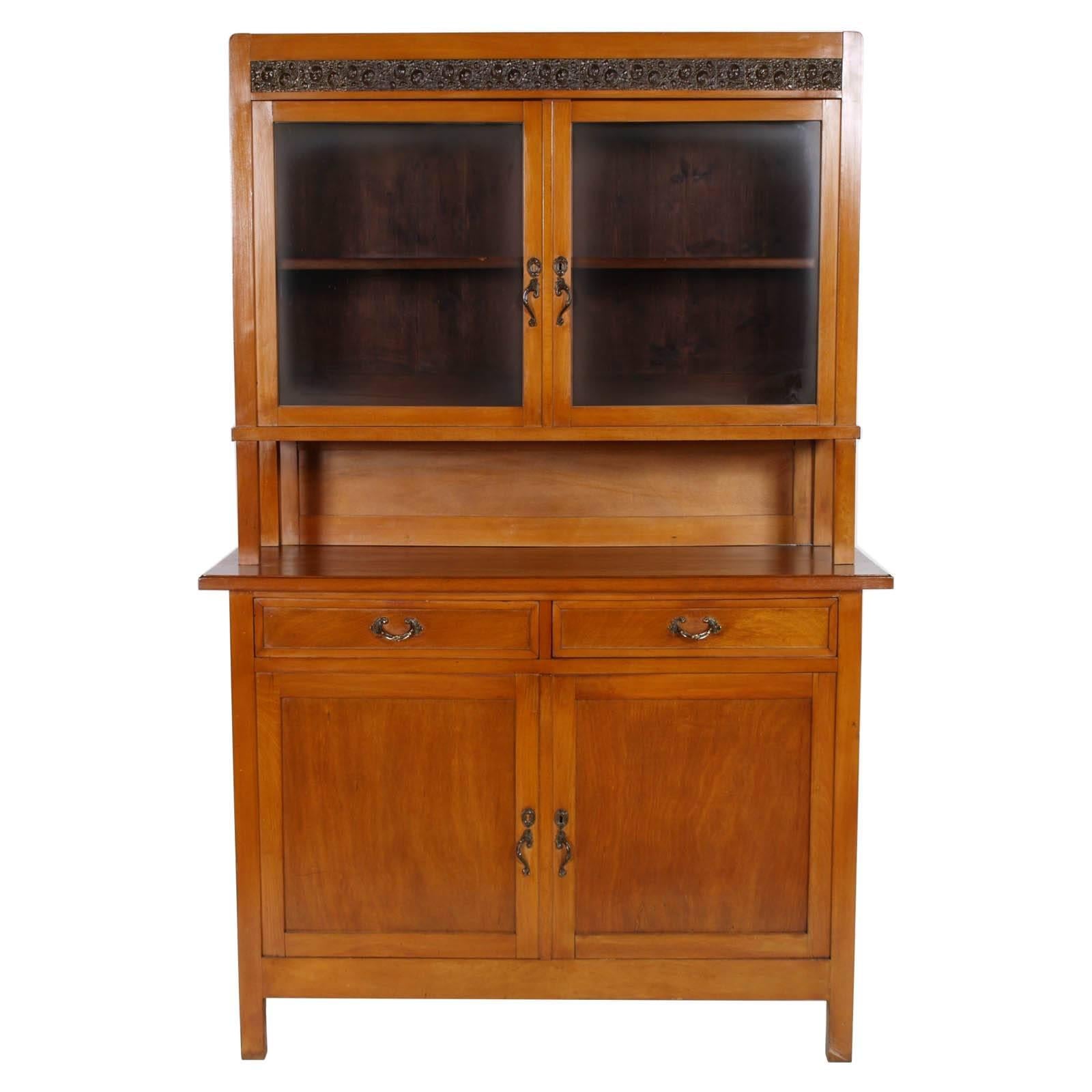 Early 20th century, Country Art Nouveau credenza with display cabinet in massive cherrywood , restored and wax polished; handles and display cabinet decoration, in bronze
Measures cm: H 205, W 142, D 52.
