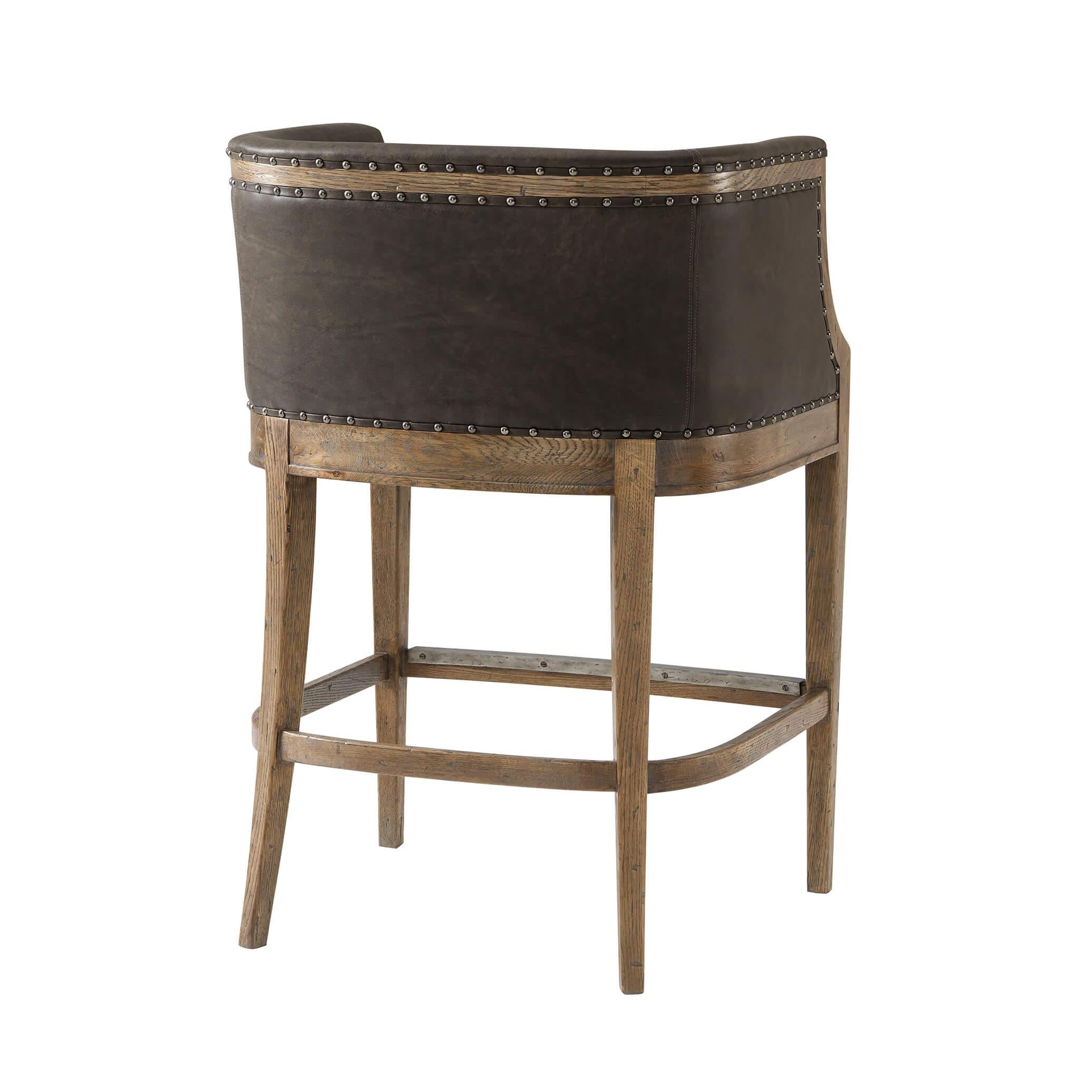 An English country bar chair in oak and leather barrel back bar chair with nailhead trim details, square tapered legs, and a stretcher base.

Dimensions: 27