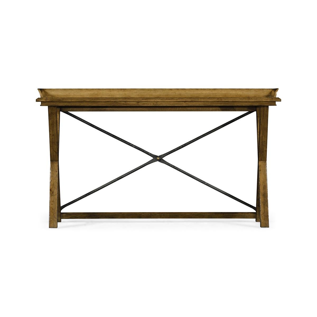 Country Chestnut console table. A narrow light brown Chestnut console table with an unusual angled gallery top with a molded edge above an X frame base with an iron cross member.

Dimensions: 58