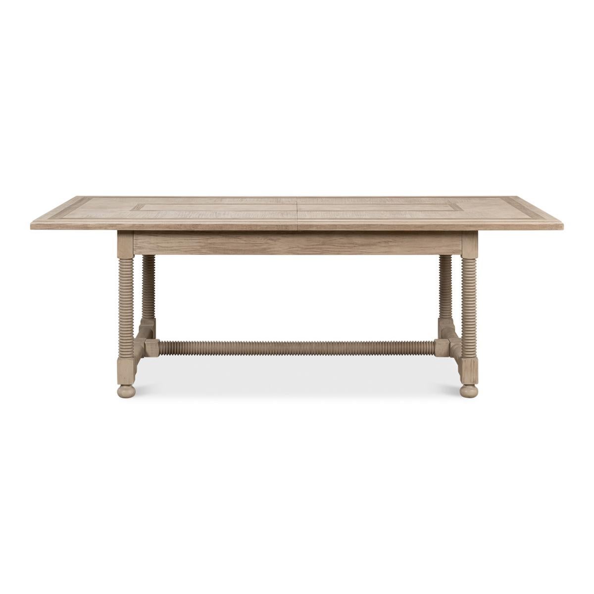 Country draw leaf extension dining table. Extending to 120 inches, the Table is a beautifully subtle masterpiece combining form and function. Constructed of pine and in our Barn Grey finish, the unusual turned legs and inlay wood pattern on the