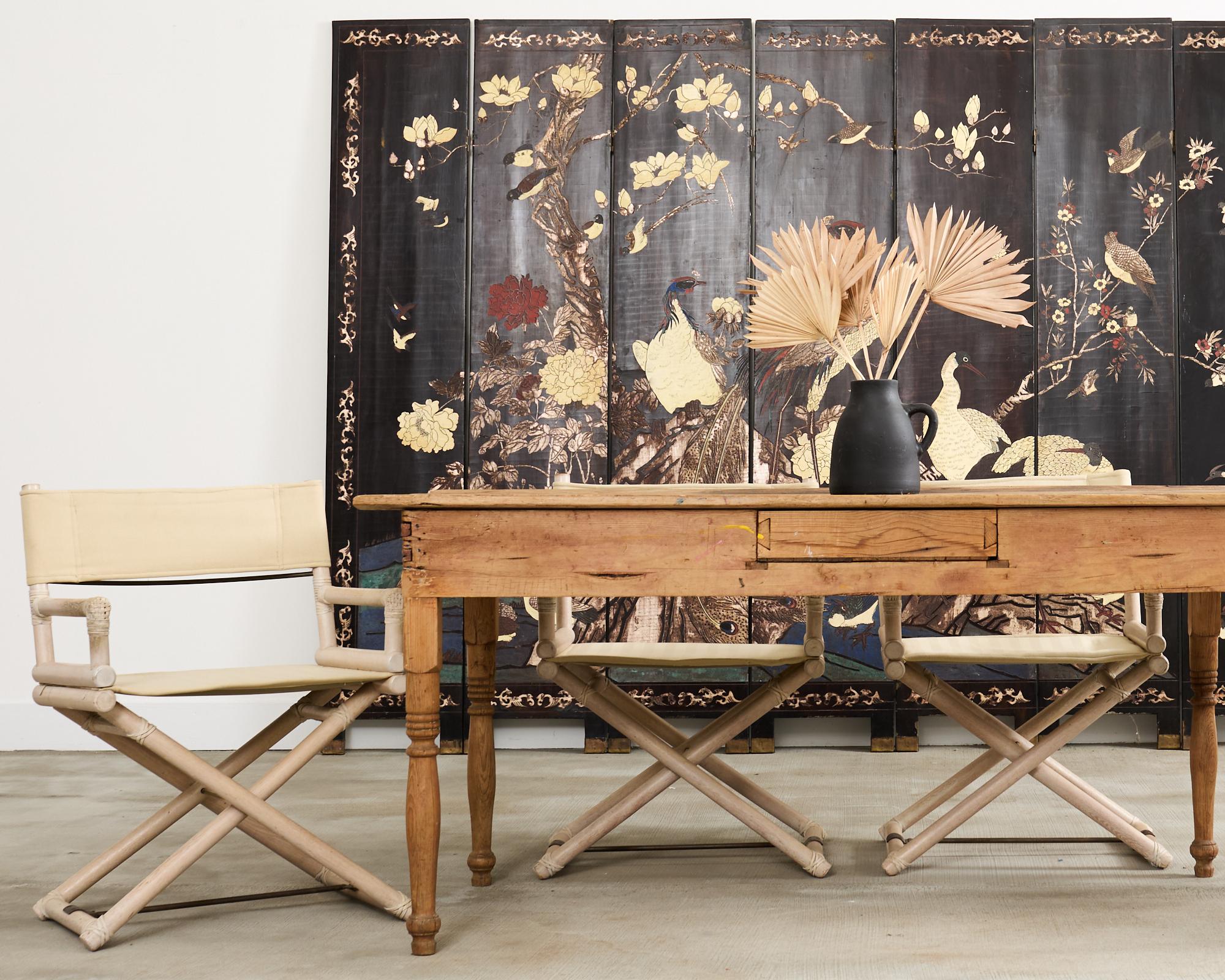 Rustic country English provincial farmhouse dining table crafted from oak and pine. The table features a desirable scraped, bleached like finish with a warm honey toned natural patina. The plank top is supported by legs with exposed boxed joint