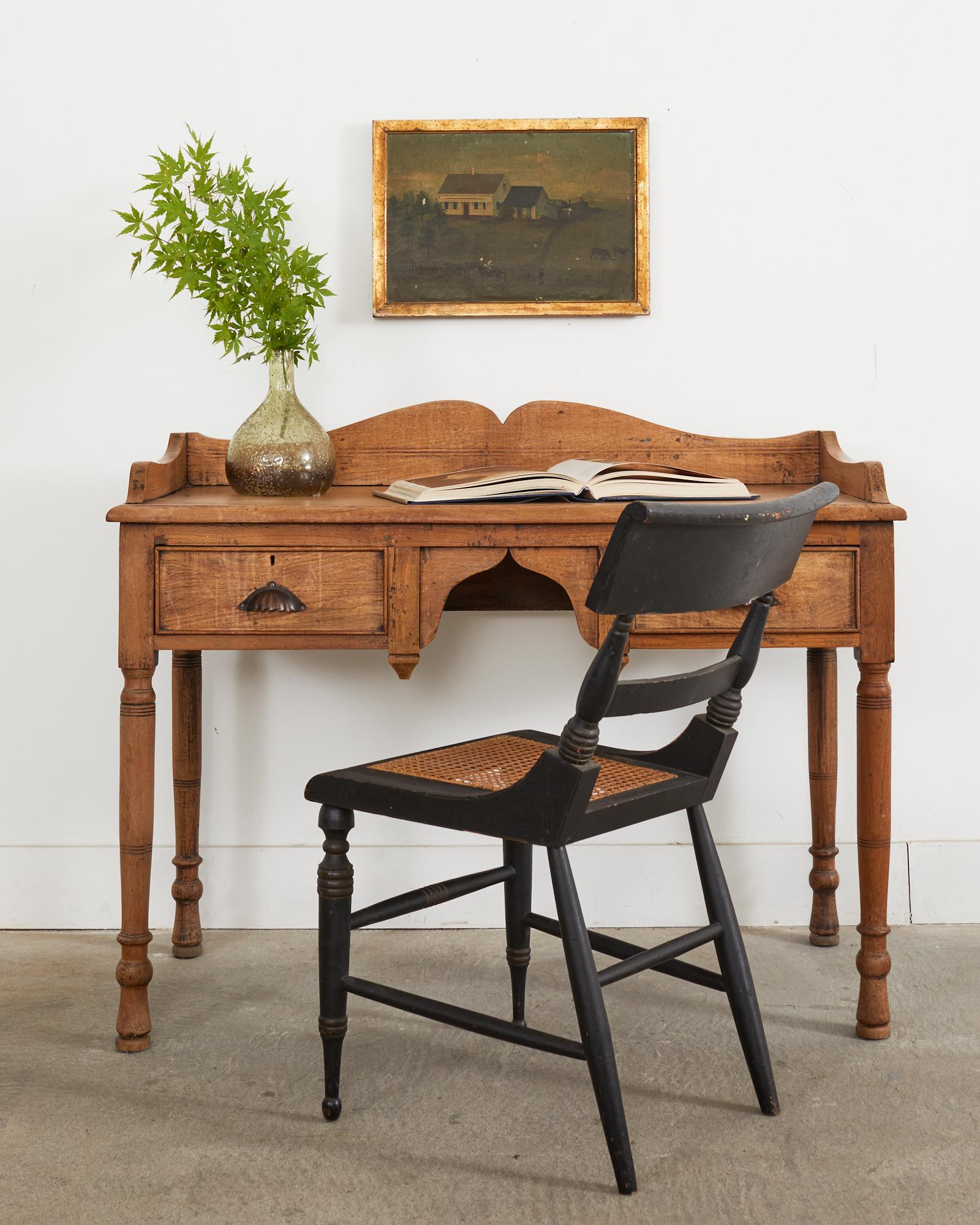 Charming country English provincial oak writing table or desk featuring a bleached or stripped finish. The oak has a lovely aged patina and soft feel with a warm honey tone. The top of the desk measures 30.5 inches high surmounted by a large
