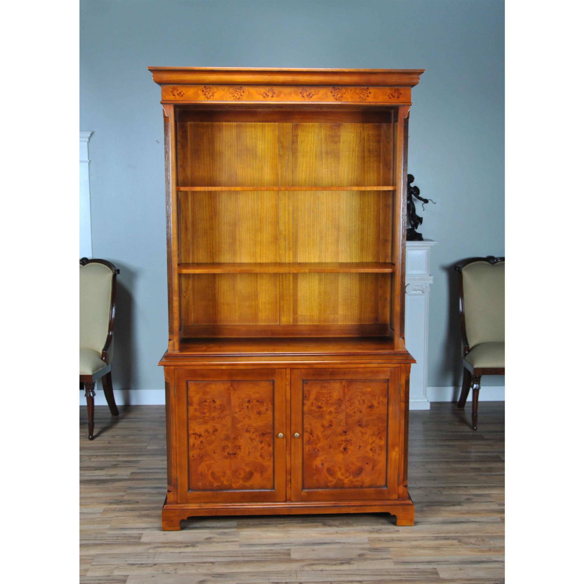 Our Country Estate Cupboard is manufactured in two sections, the upper section consisting of a deep, molded cornice with burled veneer following the shape of reeded corners rising from below, with lamb tongue detail at the top and bottom of the