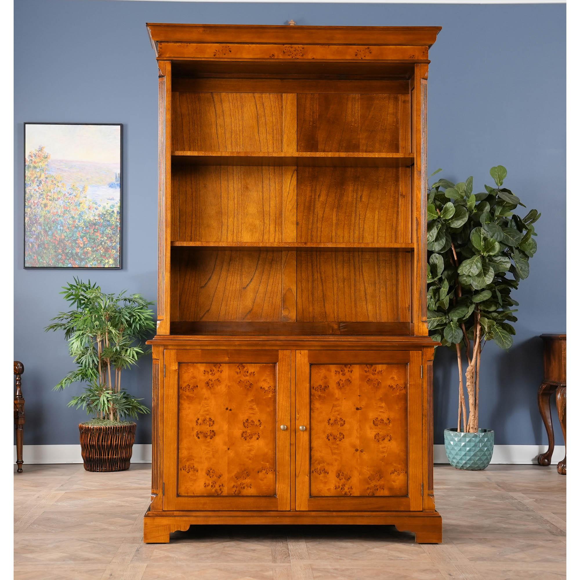 Our Country Estate Cupboard is manufactured in two sections, the upper section consisting of a deep, molded cornice with burled veneer following the shape of reeded corners rising from below, with lamb tongue detail at the top and bottom of the