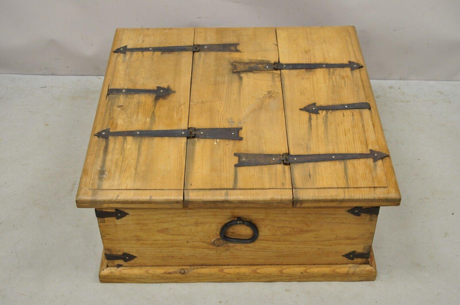 Country Farmhouse Style Mexican Double Lid Wooden Coffee Table Storage Trunk. Item features a double sided lid, cast iron hardware, solid wood construction, distressed finish, very nice vintage item, great style and form. Circa Late 20th Century.
