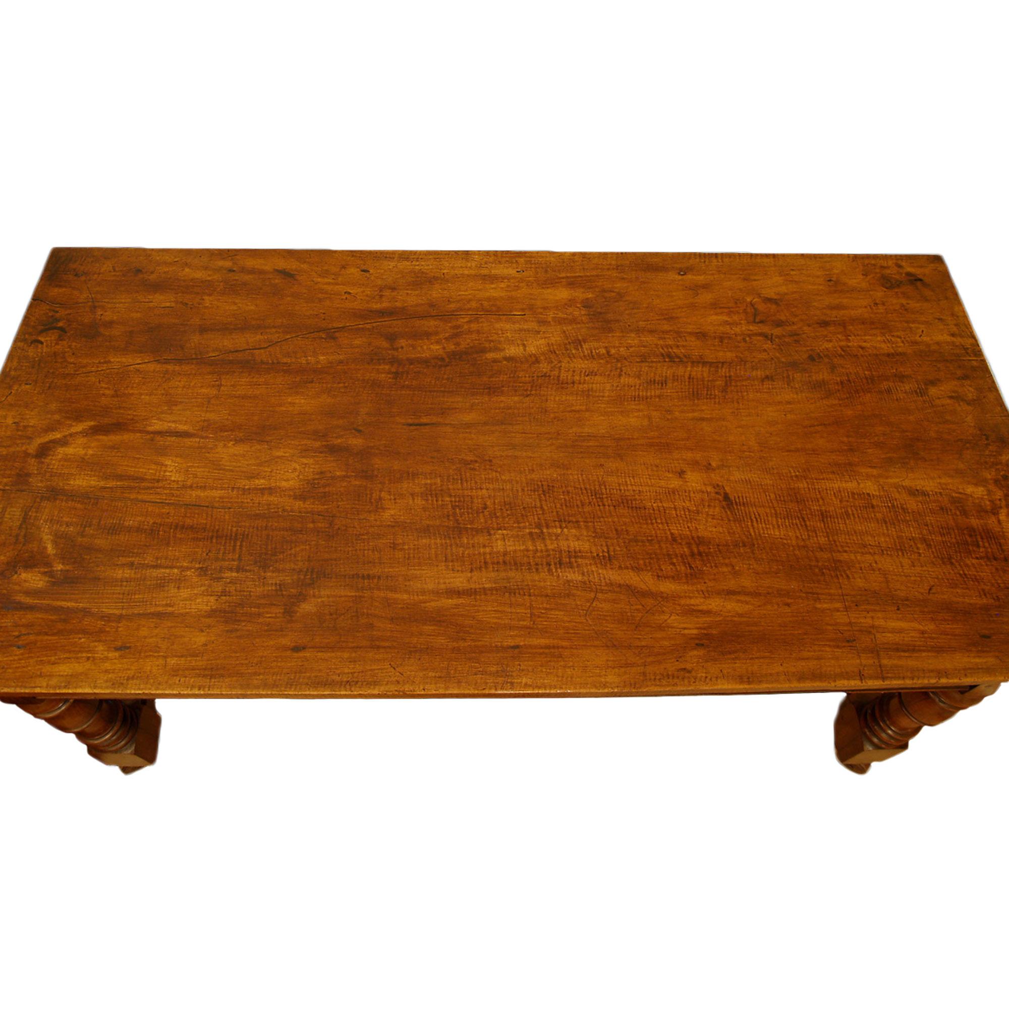 A handsome early 19th century country French Louis XIII st. walnut rectangular multi functional table. The table is raised by four turned legs and their original and large scale wood and iron casters. The legs are joined by an 'H' stretcher. The